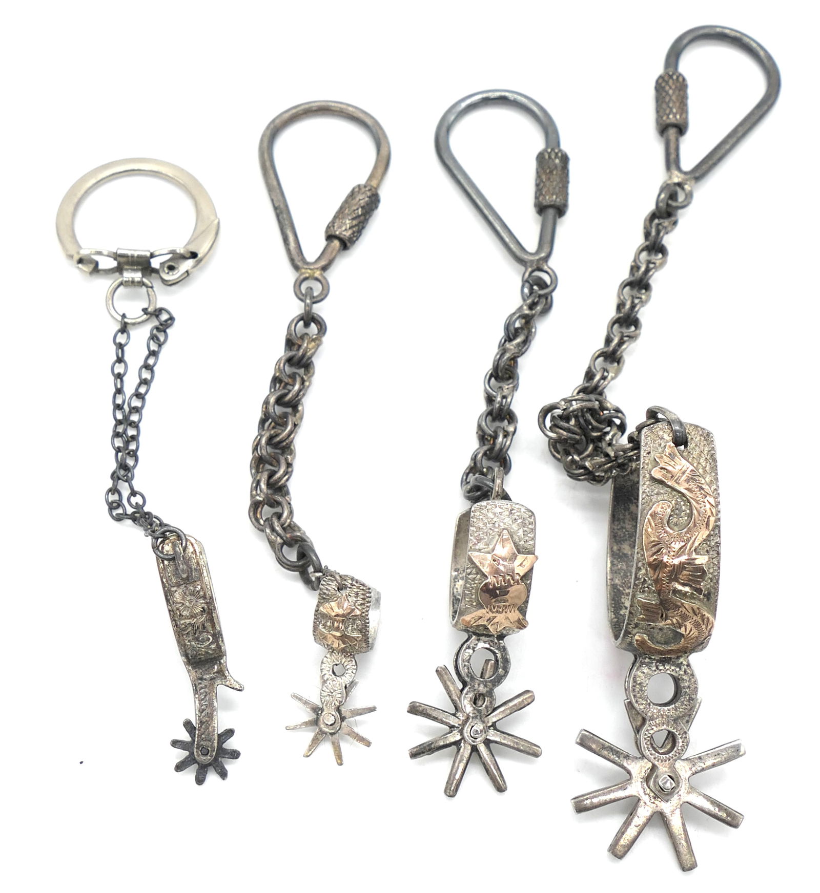 Four Sterling Spur Keychains: Four sterling spur keychains marked largest to smallest as follows: Mexico 925 13K, Mexico 925 13K, sterling, 925. Total weight: 2.57 ozt Size: Largest total length 6"L