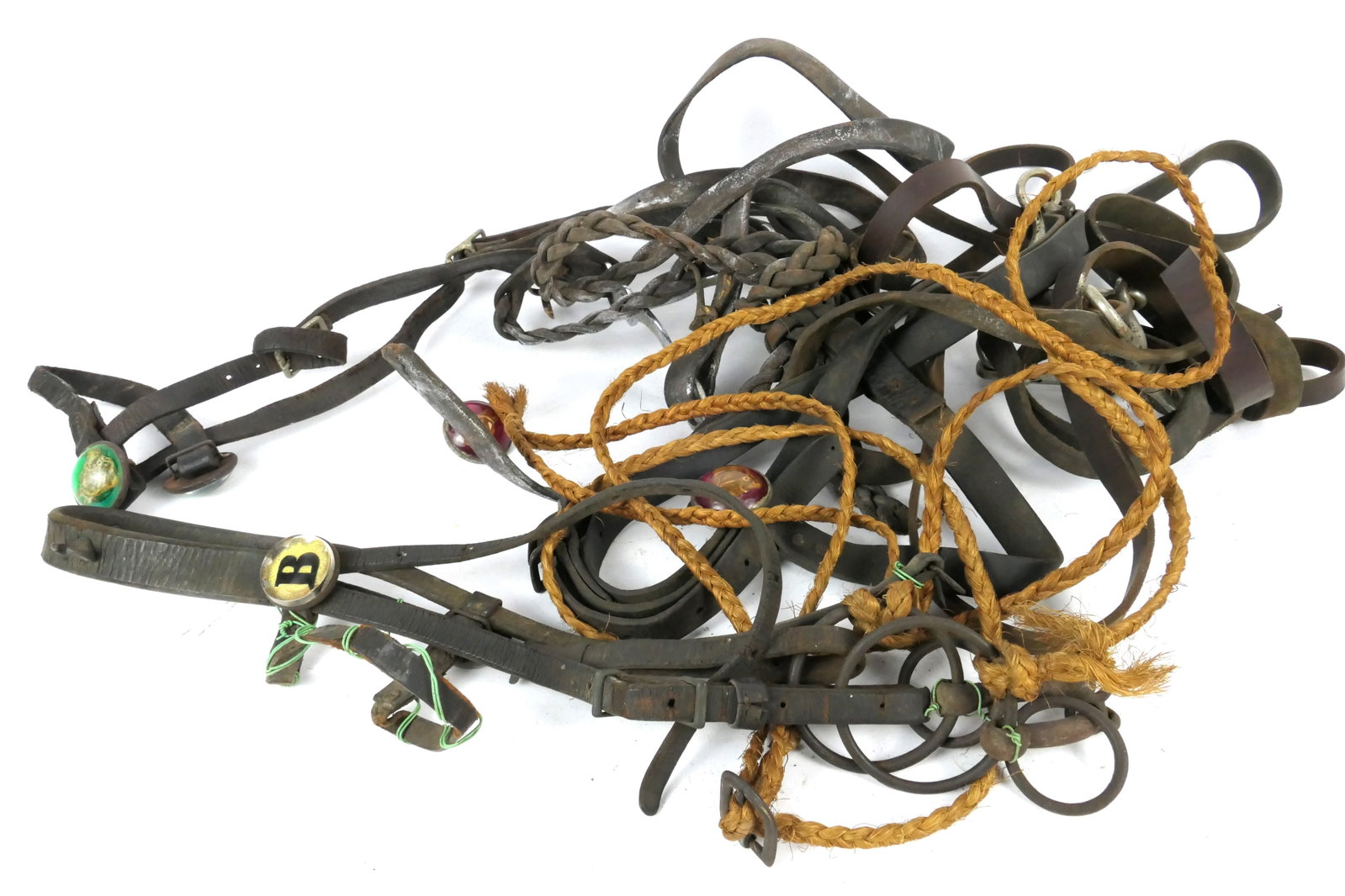 Bridles with Antique Rosettes: Bridles with red and green glass domed horse head rosettes and "B". Rough condition.