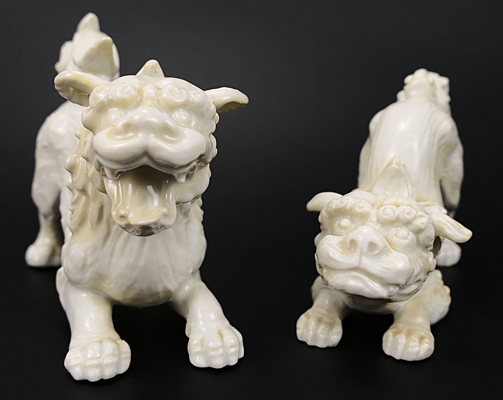 Circa 1960's Playful Foo Dogs by Fitz and Floyd: Circa 1960's playful foo dogs by Fitz & Floyd. One has a chip on the back. Marked F22/31. Size: Largest 7.5"w x 5"h