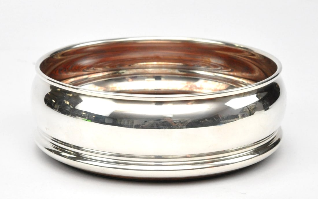 Sterling Silver Wine Coaster: Sterling silver wine coaster with wooden base. It is unmarked but tested positive for silver. Size:5"dia