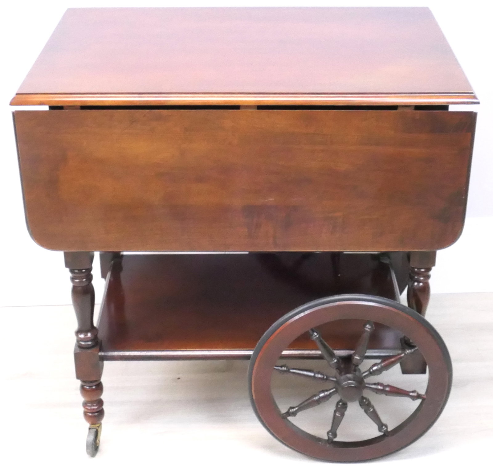 Tea Cart with Drop Leaves: Tea cart by Ross Furniture with spring loaded double drop leaves, bottom shelf and guiding handle. Size: 28"w x 19.5"d with leaves down x 28"h, each leaf 9.5"w