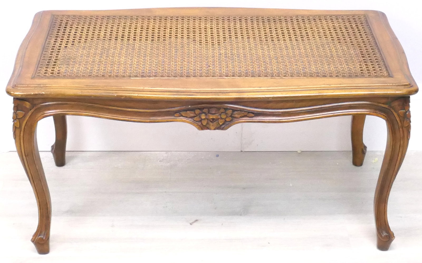 Carved Wood Coffee Table with Caning: Carved wood coffee table with caned top, carved apron with flower designs and cabriole legs. Size: 32.5"w x 18"d x 17"h