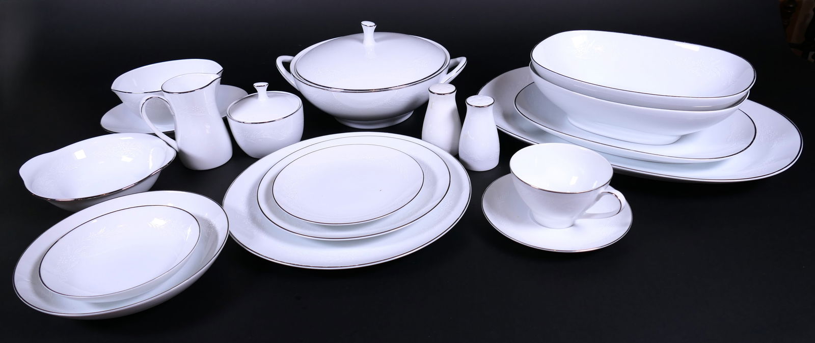 Two Shelves of Noritake Georgian Place Settings for Twelve and More: Two shelves of Noritake "Georgian" place settings for more than (12) including (15) dinner plates, (13) soup bowls, (14) fruit bowls, (17) salad plates, (17) bread plates, (13) cups and (14) saucer. P