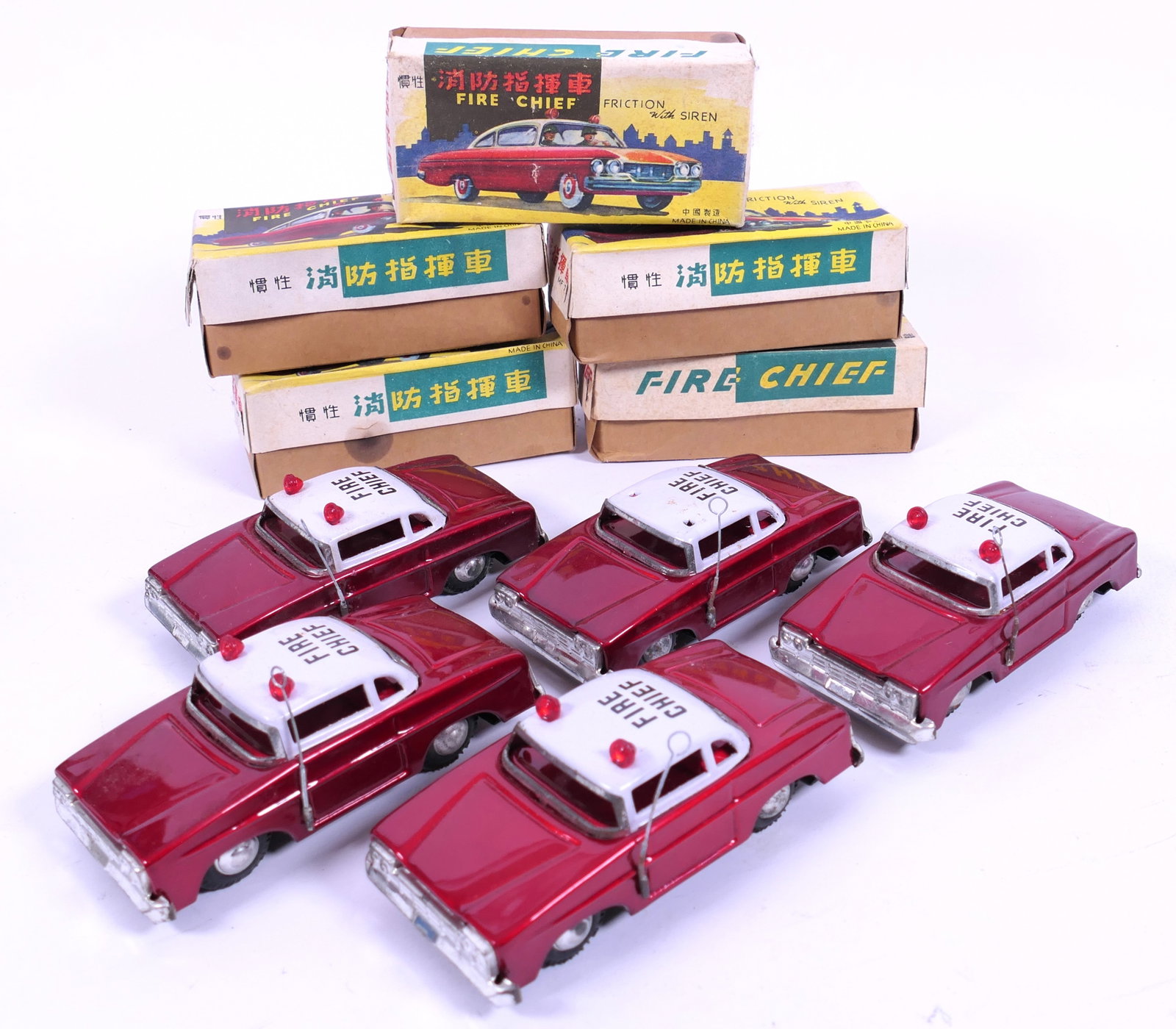 Five 1960's Tin Friction Fire Cars: Five 1960's tin friction fire chief cars model MF-714 with boxes. Boxes show damage, toys appear in good condition. One car missing siren lights. Size: 5.75"L x 2.5"d x 2.5"h Location: Front Bedroom