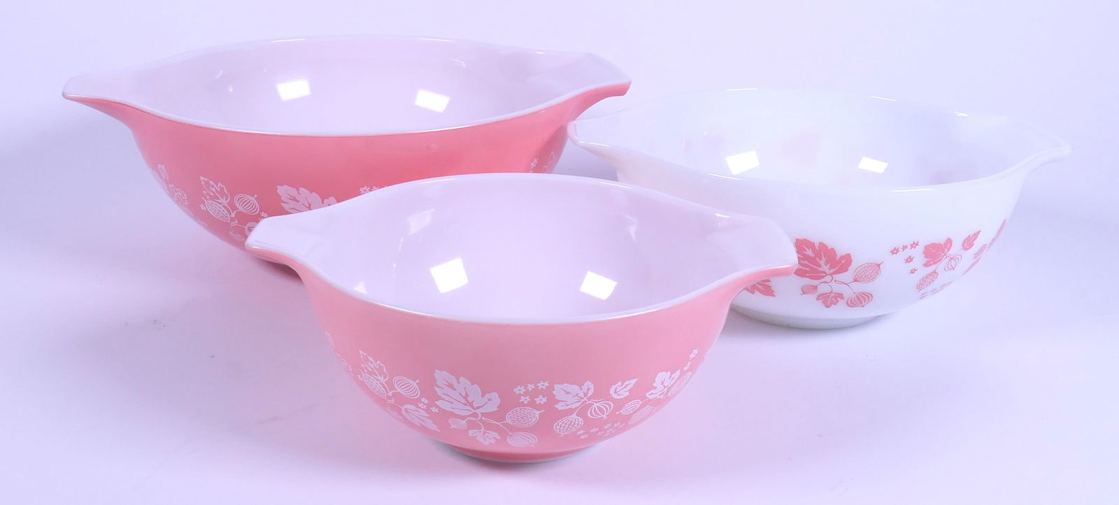 Three 1960's Cinderella Mixing Bowls: Three 1960's Pyrex Cinderella nesting bowls in Pink Gooseberry. Slight scratching on largest bowl. Size: 10.25"dia x 4.5"h Location: Kitchen