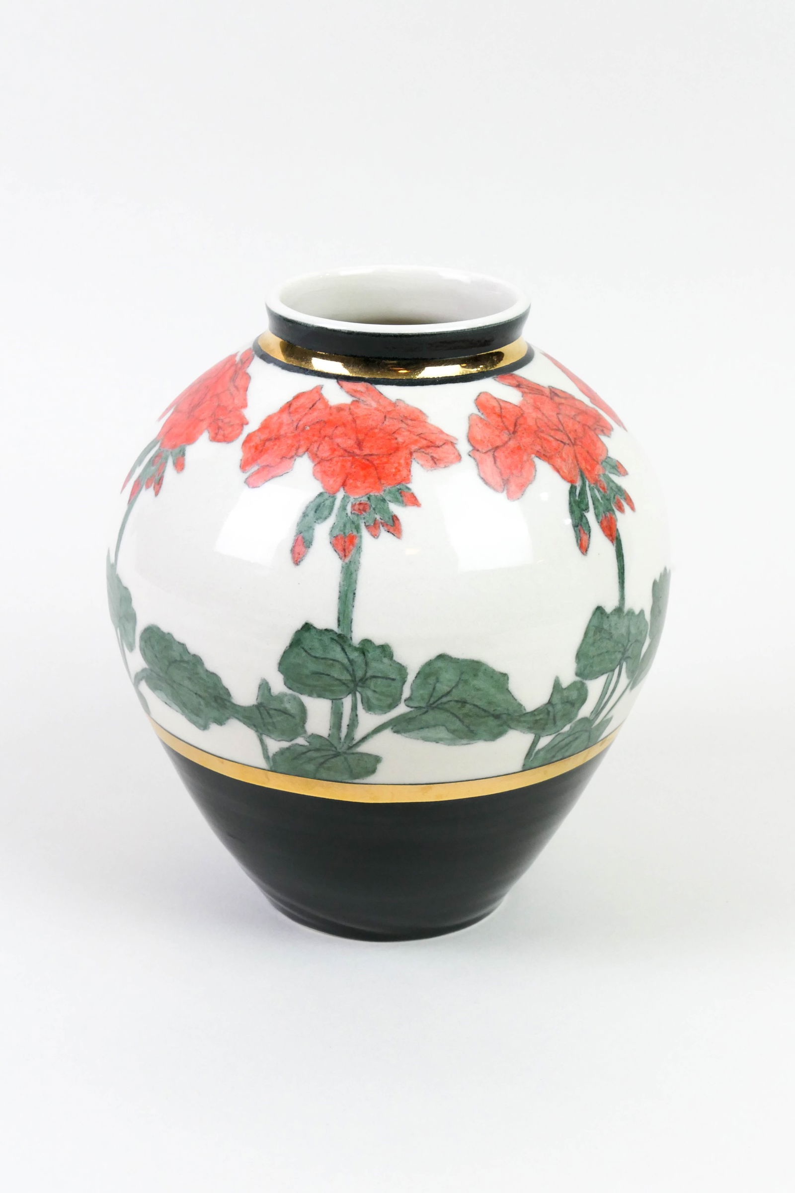 Mary Dobson Hand-Thrown Vase: Hand-thrown and decorated art pottery vase by Mary Dobson, featuring a black and gold-tone banded design surrounding a repeating red floral and foliate motif. Artist signed on the bottom. Surface fini