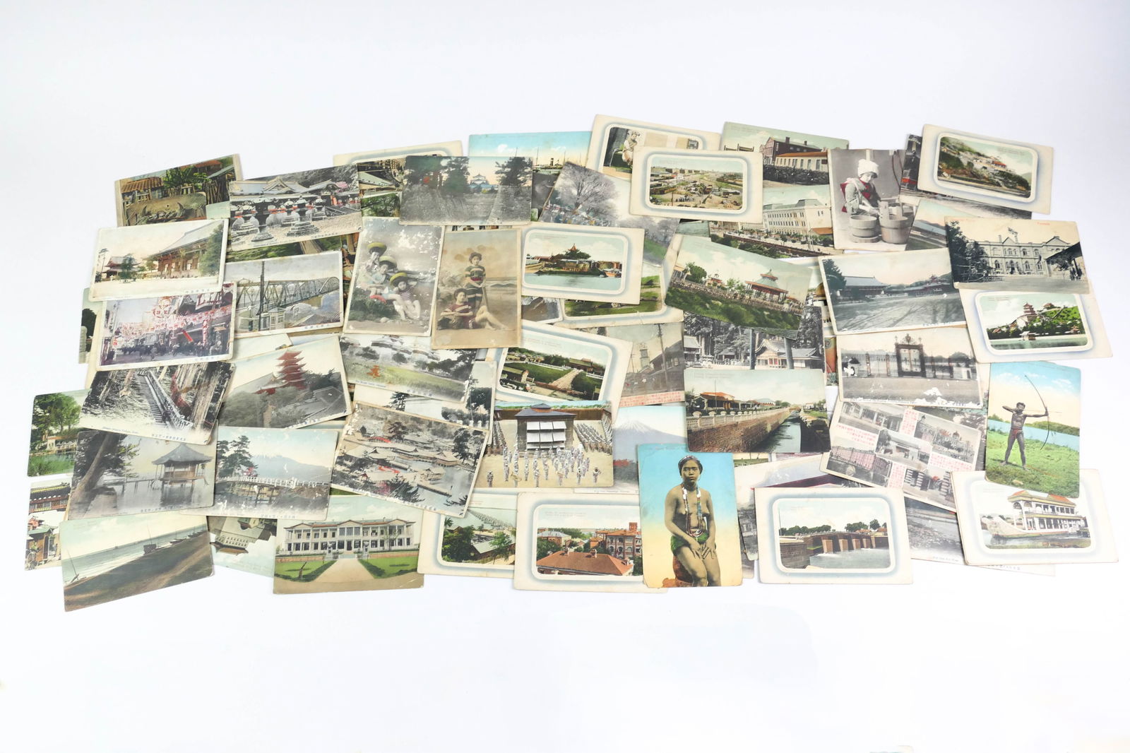 Collectible Postcards: Stack of collectible postcards including images such as what appear to be Asian scenes depicting places, people, Osaka, Philippines, temples, boats, and more. Plus four real photo postcards. All show