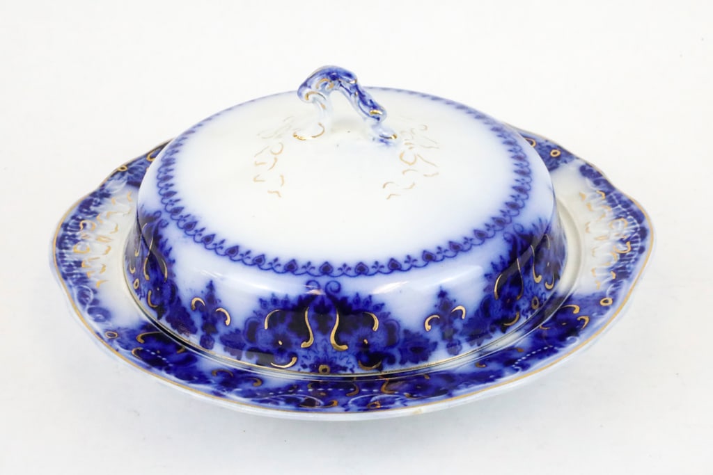 Circa 1896 Johnson Bros Lidded Butter-dish: Circa 1896 Johnson Bros lidded butter-dish in the Albany pattern. There is gold tone accenting throughout, and is marked Johnson Bros on the bottom. There is crazing throughout and the lid shows a hai