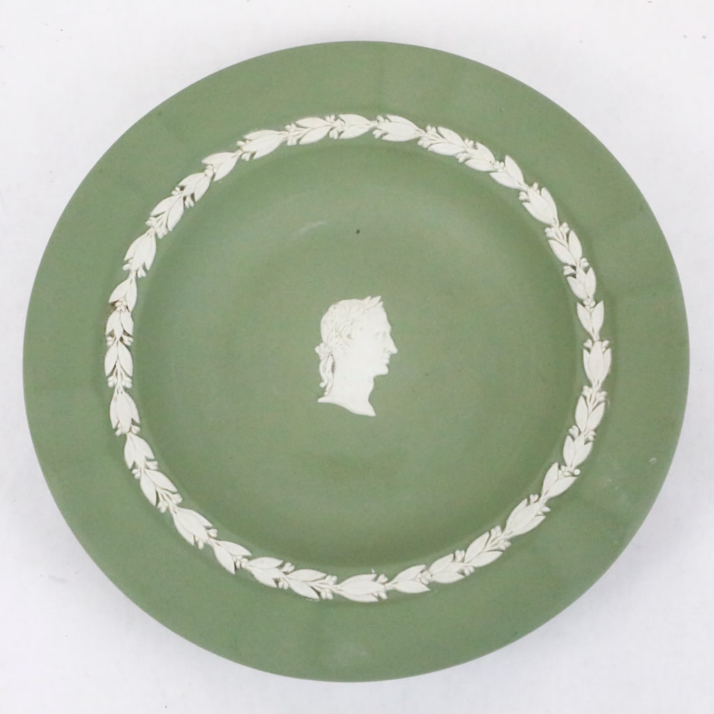 Green Wedgwood Jasperware Ashtray: Green Wedgwood jasperware ashtray, featuring a laurel border around the piece. There is a central profile motif of Julius Caesar. Marked on the bottom Wedgwood, England. Size: 7"dia