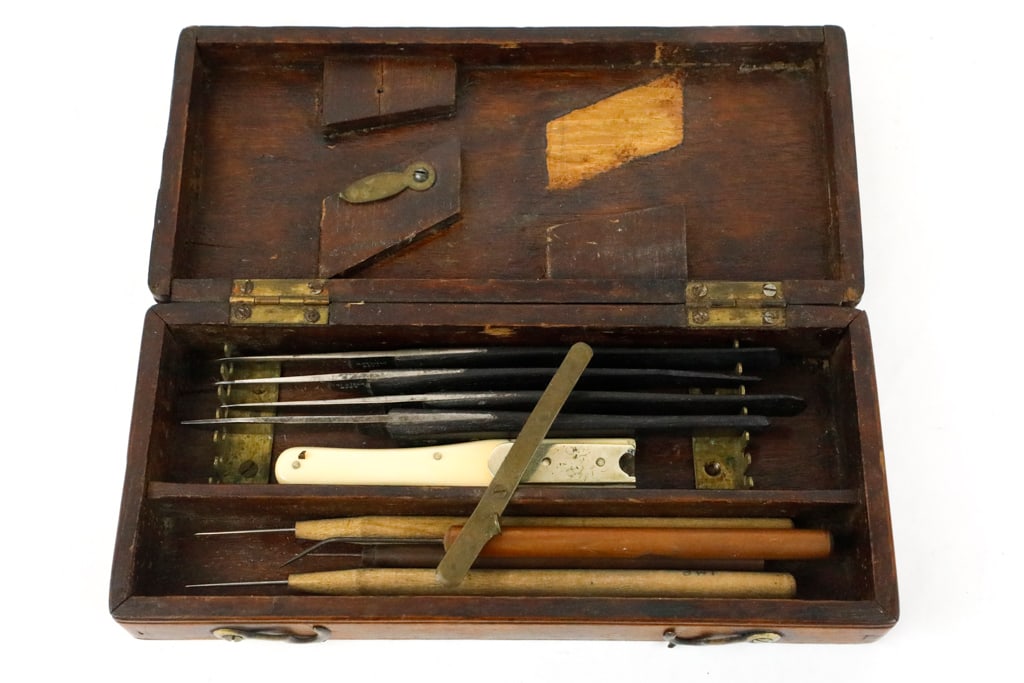 Battlefield Surgical-Medical Kit with Utensils in Walnut Hinged Box: Battlefield surgical-medical kit with utensils in walnut hinged box. There are 4 scalpels with McQueen and Son and Clark company names. The scalpels were hand forged and manufactured in Sheffield, Eng