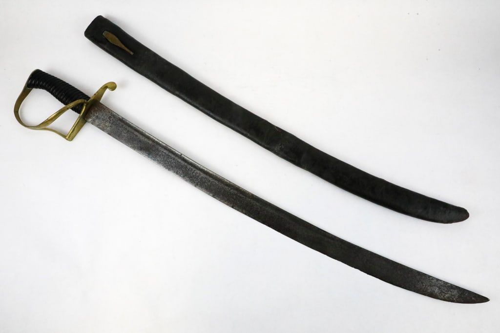 British Pattern 1861 Hospital Corp's Sword: British pattern 1861 hospital Corp's sword with a fullered, slightly curved blade variant. The guard is made of brass with a painted cast iron ribbed grip. Leather scabbard with brass frog attachment