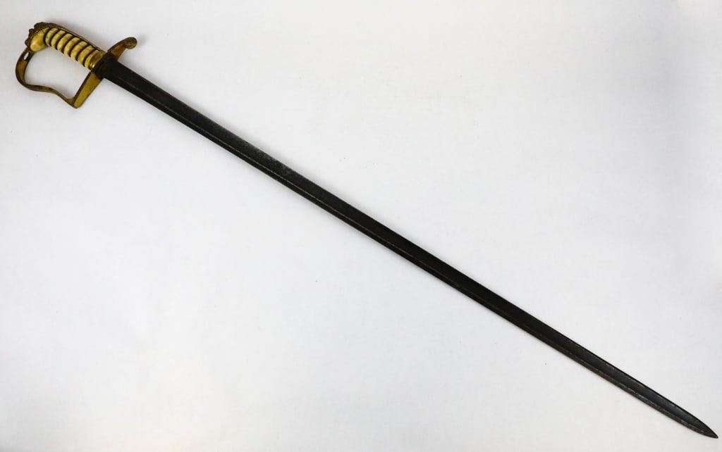 Pattern 1805 British Royal Naval Officers Sword: Pattern 1805 British royal naval officers sword with lions head pommel. The grips are ivory with the wire wrap still intact. There is a brass stirrup style hilt with longest that have been removed fro