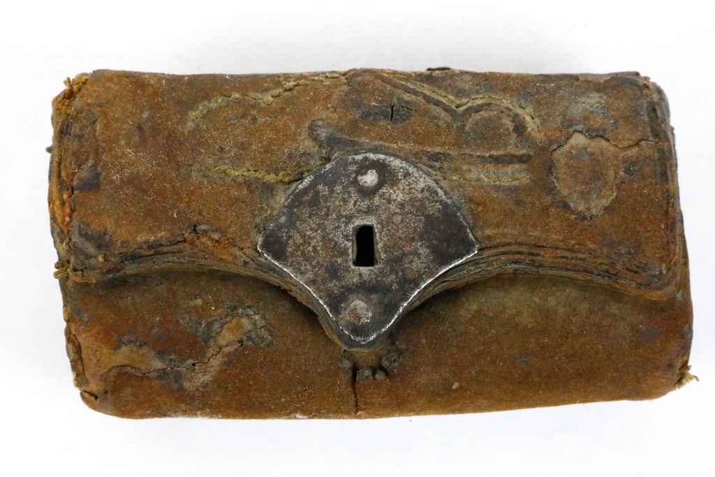 Colonial Hand-Stitched Leather Pouch: Colonial hand-stitched leather pouch that was possibly used as a tool sheath, knife case, or persona pouch. The handmade leatherwork shows wear. There pouch features a simple iron lock plate on the fr