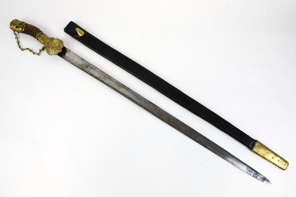 German Hanger Steel Blade Hunting Sword: German hanger hunting sword with steel blade, displaying contact marks. No engraving or makers name is seen on the blade. Embossed hunting symbols are featured on the brass shell. There is a slag hand