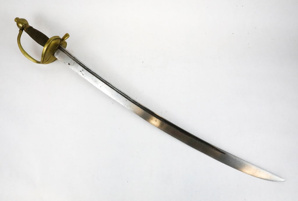 1840 Non-Commissioned Officer Sword: 1840 Non-commissioned officer sword with short blade. No visible maker on the curved blade. Features double brass guards, and a brass braided handle with a pommel finial. Size: Blade: 23"l, Full Lengt