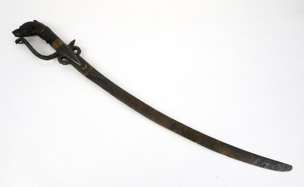 Kastane Traditional Ceremonial Sword: Kastane traditional ceremonial sword from Sri Lanka, representing rank and carried by noblemen and chiefs of the Kandyan court. This sword reveals a short curved blade, hilt with knuckle guard featuri