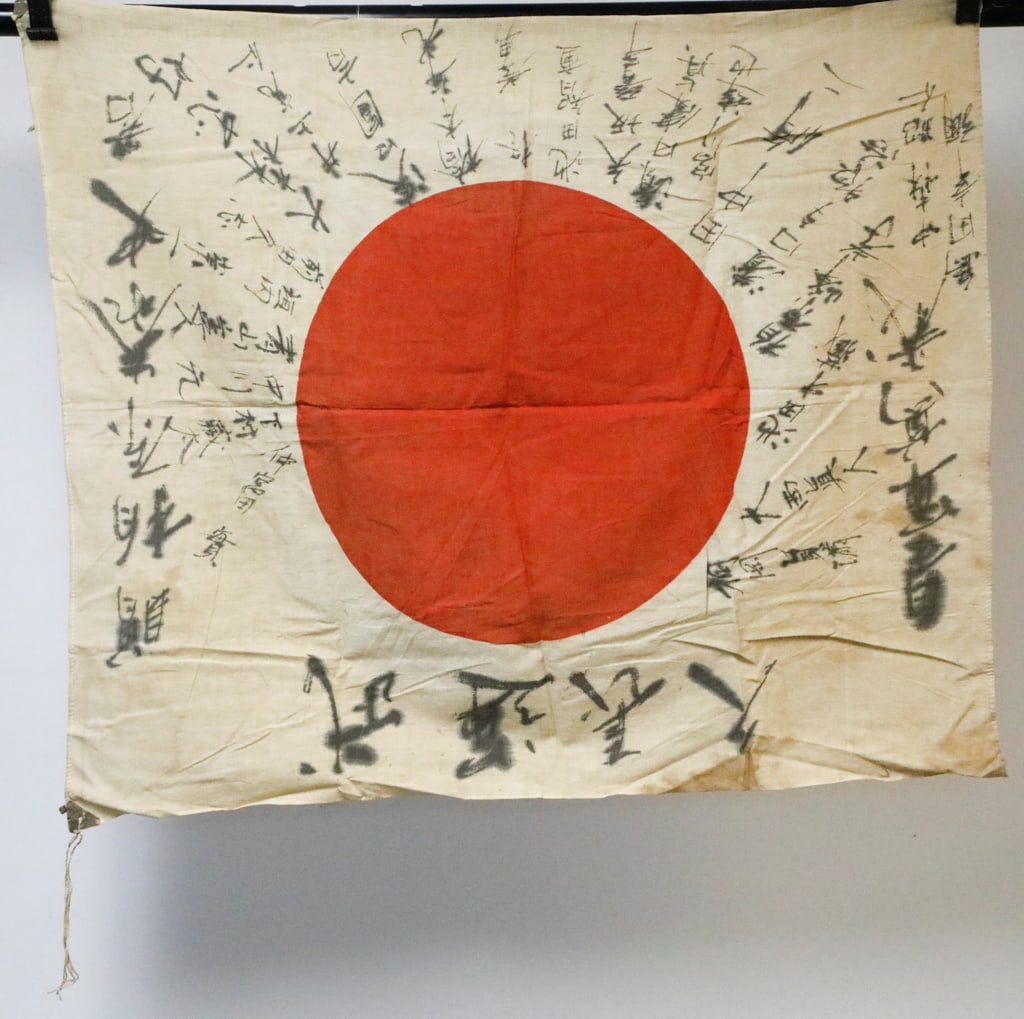 World War II Era Japanese Flag: World War II Era Japanese flag, known as a good luck flag (Yosegaki Hinomaru). These flags were carried by soldiers as personal talismans for protection. There is handwritten calligraphy consisting of