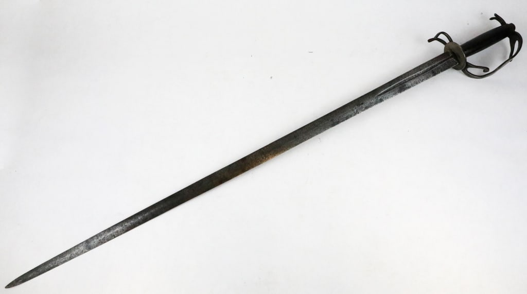 Antique European Rapier Sword: Antique European rapier sword popular for their long slender double edged blades and complex hilts to protect the hands. The sword shows narrow pointed blade with single tree mark above the picasso, p