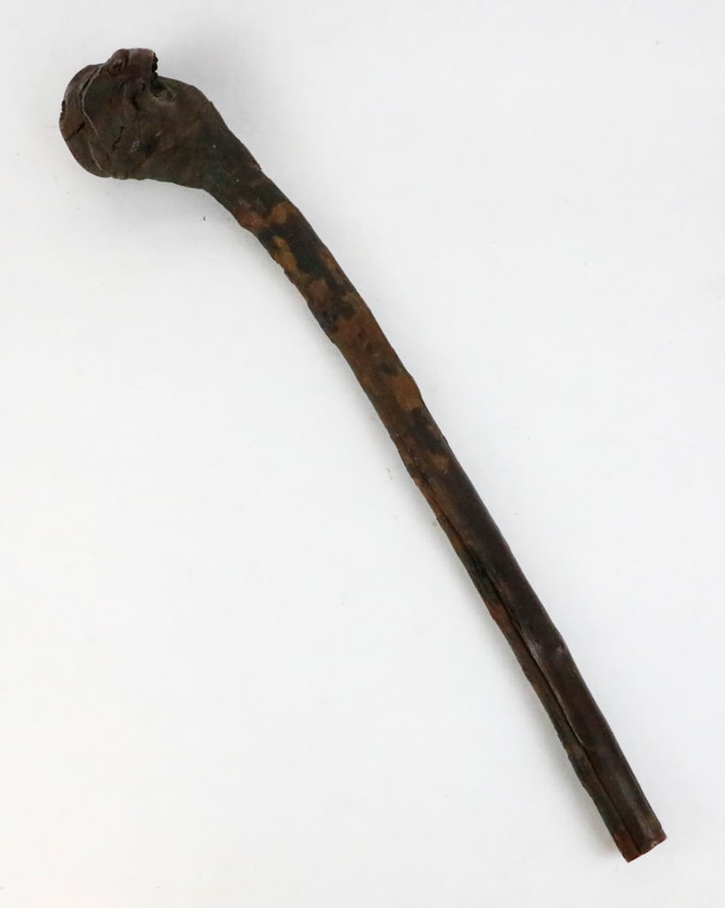 Wooden Hand Club: Wooden hand club, that appears to be made from a natural root burl. The club is short, so it was most likely used as a striking weapon or ceremonial staff. The club is a dark brown color. The wood sho