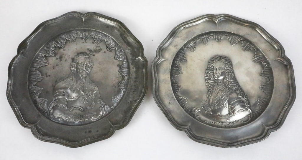 Two Pewter Portrait Plates: Prinz Eugen and Graf Von Sappenheim: Two pewter portrait plates: Prinz Eugen and Graf Von Sappenheim. Both plates depict a relief portrait inside a rococo-style border and scalloped edge. Both plates have three maker's hallmarks on the b