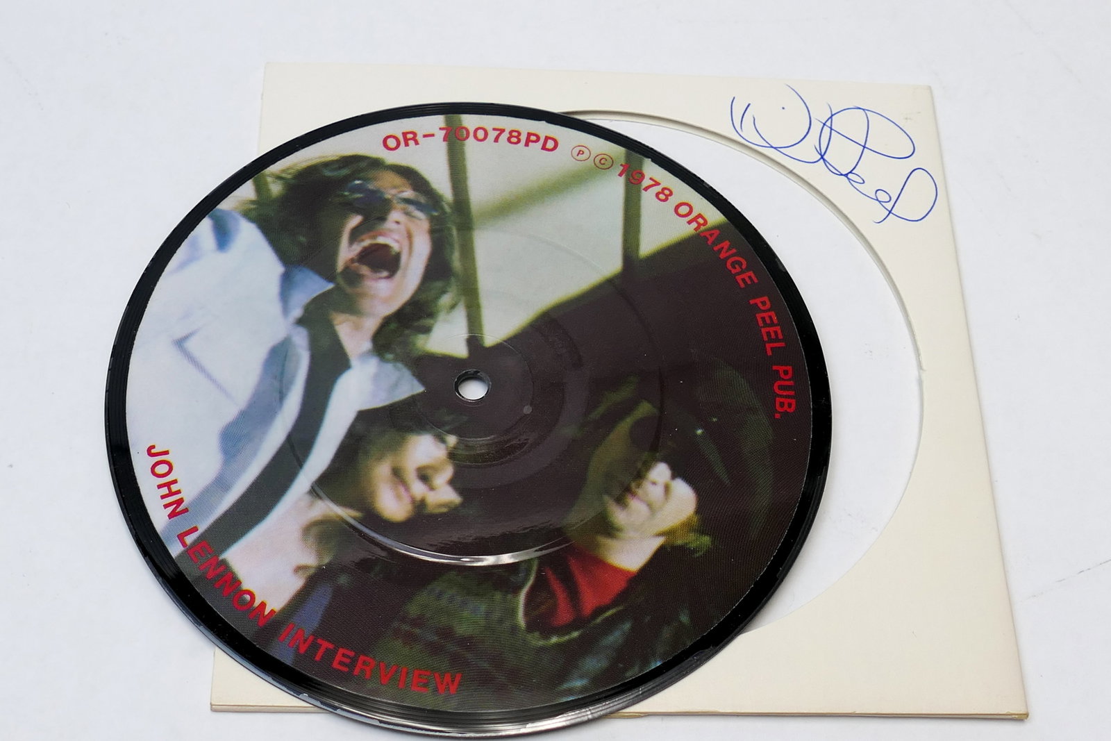 Signed John Lennon Interview Picture 45RPM: Picture vinyl 45RPM record, marked 1978 Orange Peel Pub John Lennon Interview, and 1980 In My Life, David Peel and the Apple Band. There is a signature on the record sleeve, appearing to read 'Peel',