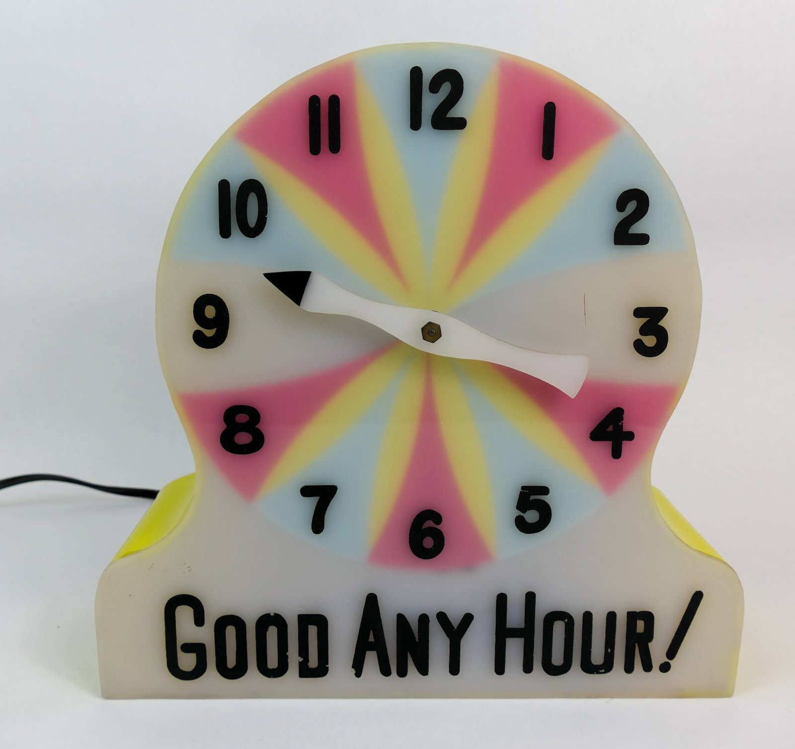 Mid-Century Good Any Hour Miracle Clock: Mid-century style gambling clock featuring a yellow plastic case, and the line Good Any Hour! across the bottom. The clock lights when plugged in, and makes a repetitive mechanical noise. The dial on