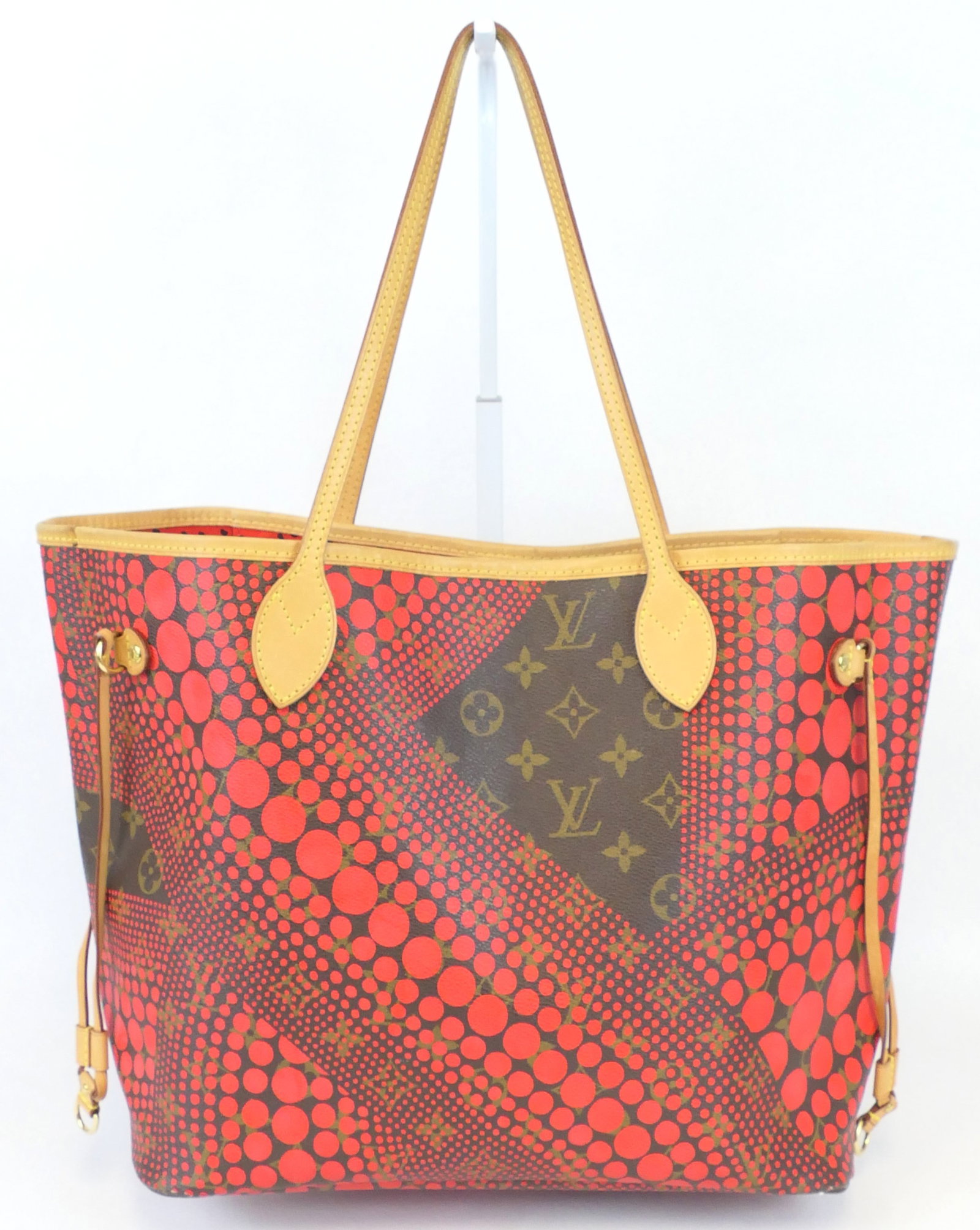 Louis Vuitton x Yayoi Kusama Neverfull Tote in Red Wave Dot: Louis Vuitton x Yayoi Kusama Neverfull Tote in Red Wave Dot with vachetta leather trim, gold tone hardware and fabric interior, 2012. Excellent condition. Size: 17"w x 5.25"d x 11"h