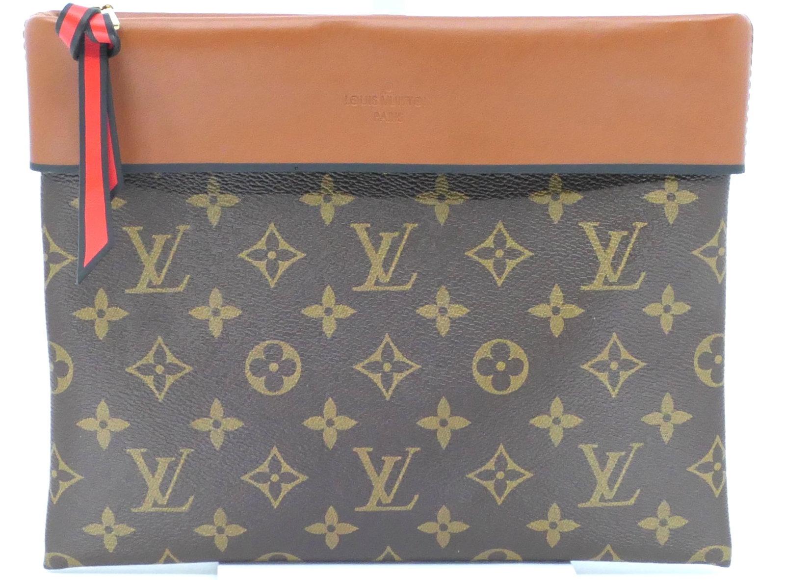 Louis Vuitton Tuileries Pochette Monogram Canvas Bag: Louis Vuitton Tuileries Pochette in classic monogram canvas with vachetta leather trim, gold tone hardware and red interior, 2017 Serial #CA4167. Excellent condition. Size: 10"w x 8"h