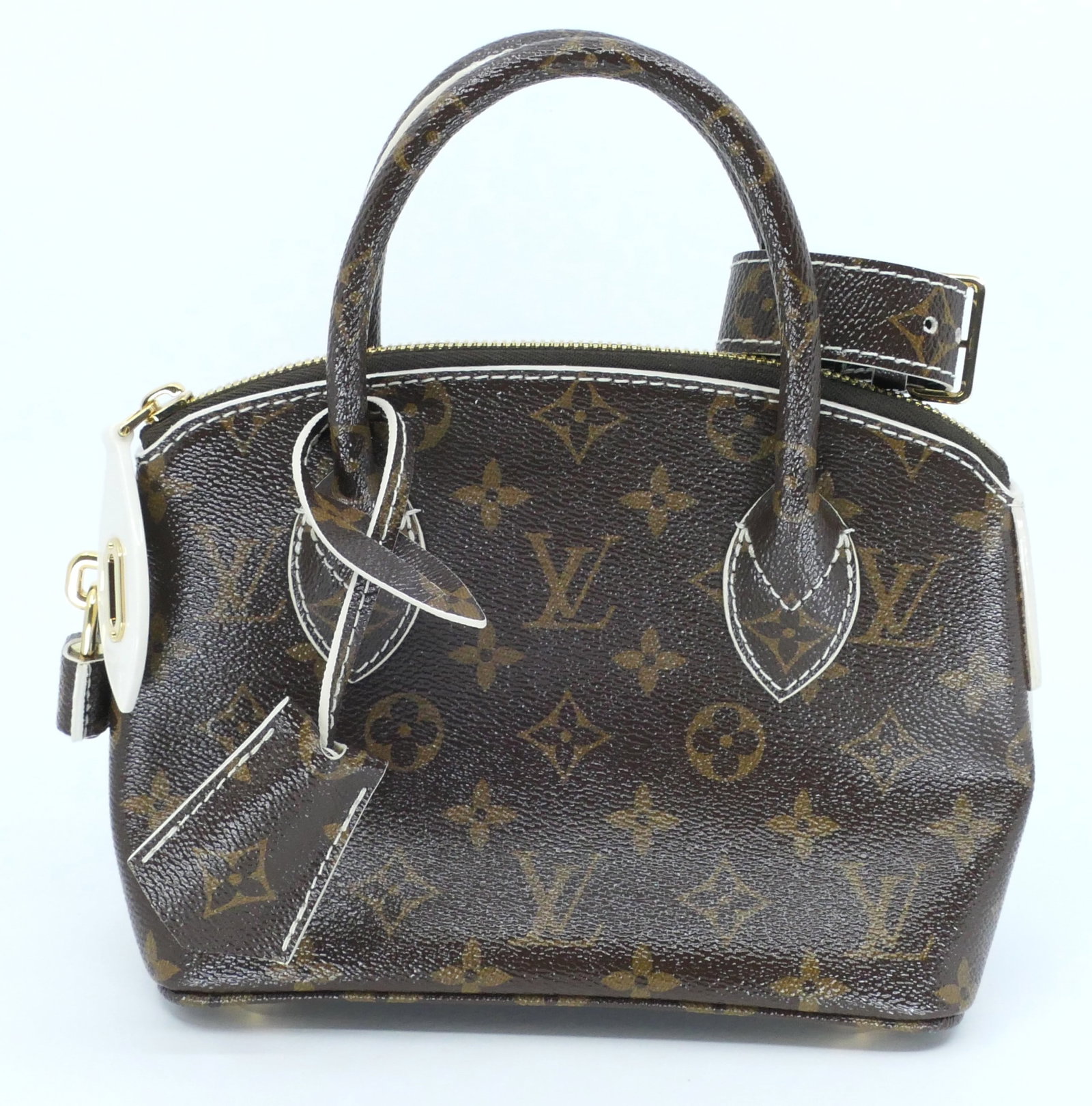 Louis Vuitton Lockit BB Monogram Canvas Bag: Louis Vuitton Lockit BB bag classic monogram canvas from the Automne-Hiver Collection with vachetta leather trim, gold tone hardware and leather interior, 2011-2012. Serial #`AR3101. Excellent conditi