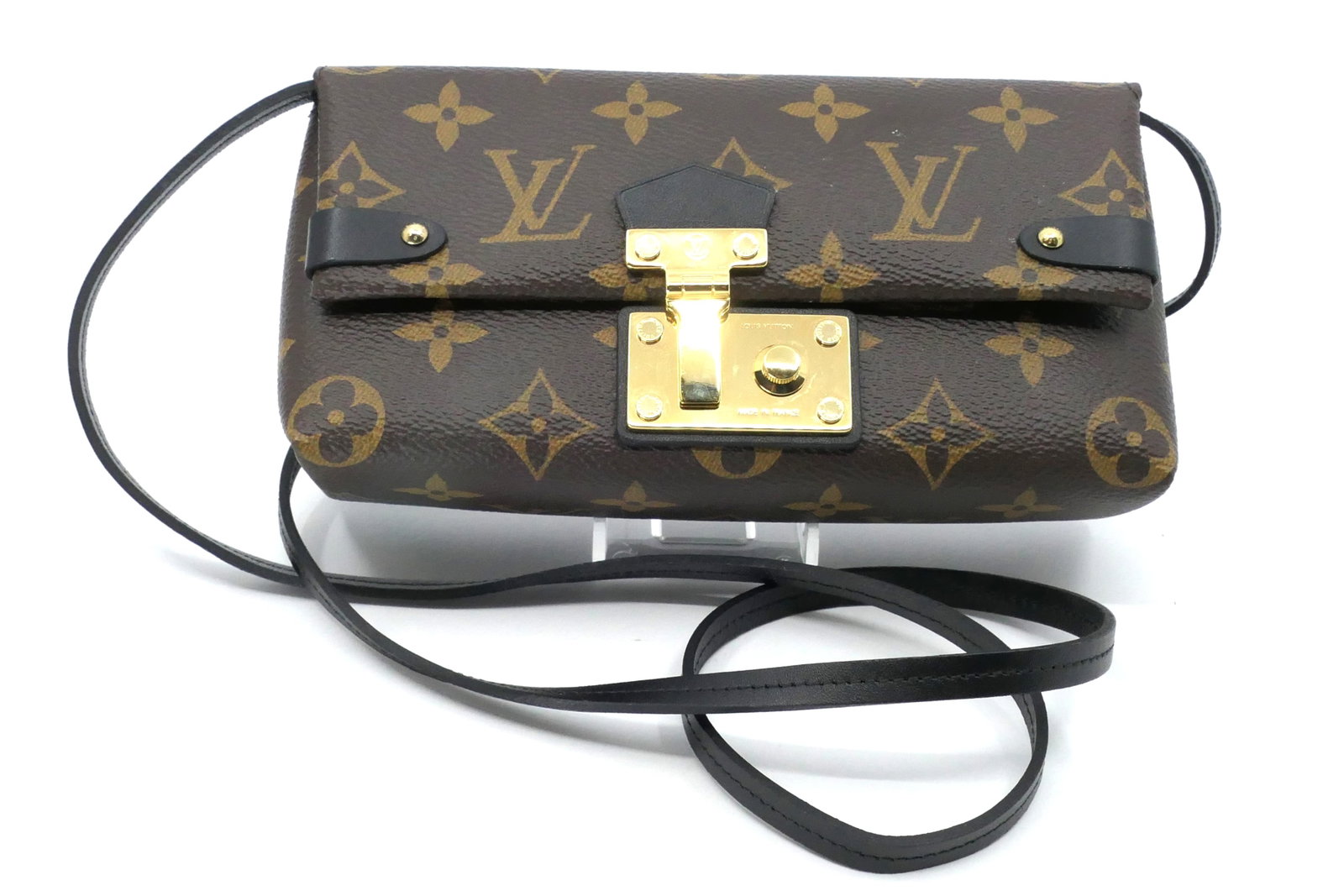 Louis Vuitton Triangle Crossbody Wallet in Monogram Canvas: Louis Vuitton Triangle crossbody wallet in classic monogram canvas with vachetta leather trim, gold tone hardware and leather interior, 2015. Serial #SF2185. Size: 7"w x 2"d x 3.5"h `