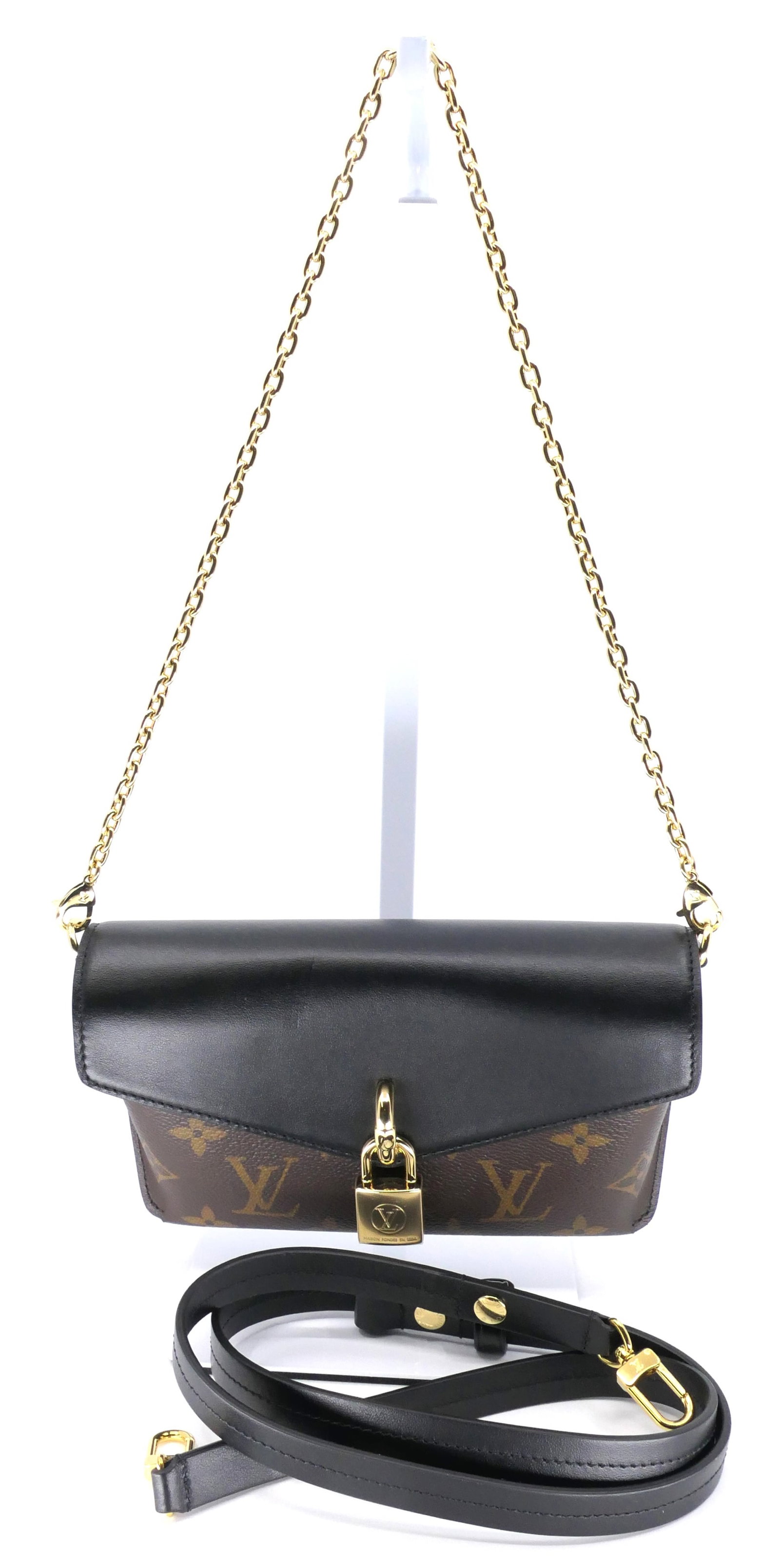 Louis Vuitton Clutch/ Crossbody in Monogram Canvas: Louis Vuitton Clutch/ Crossbody in noir and classic monogram canvas with vachetta leather trim, gold tone hardware with padlock on starp. Excellent condition, appears new. Size: 7"w x 4"h