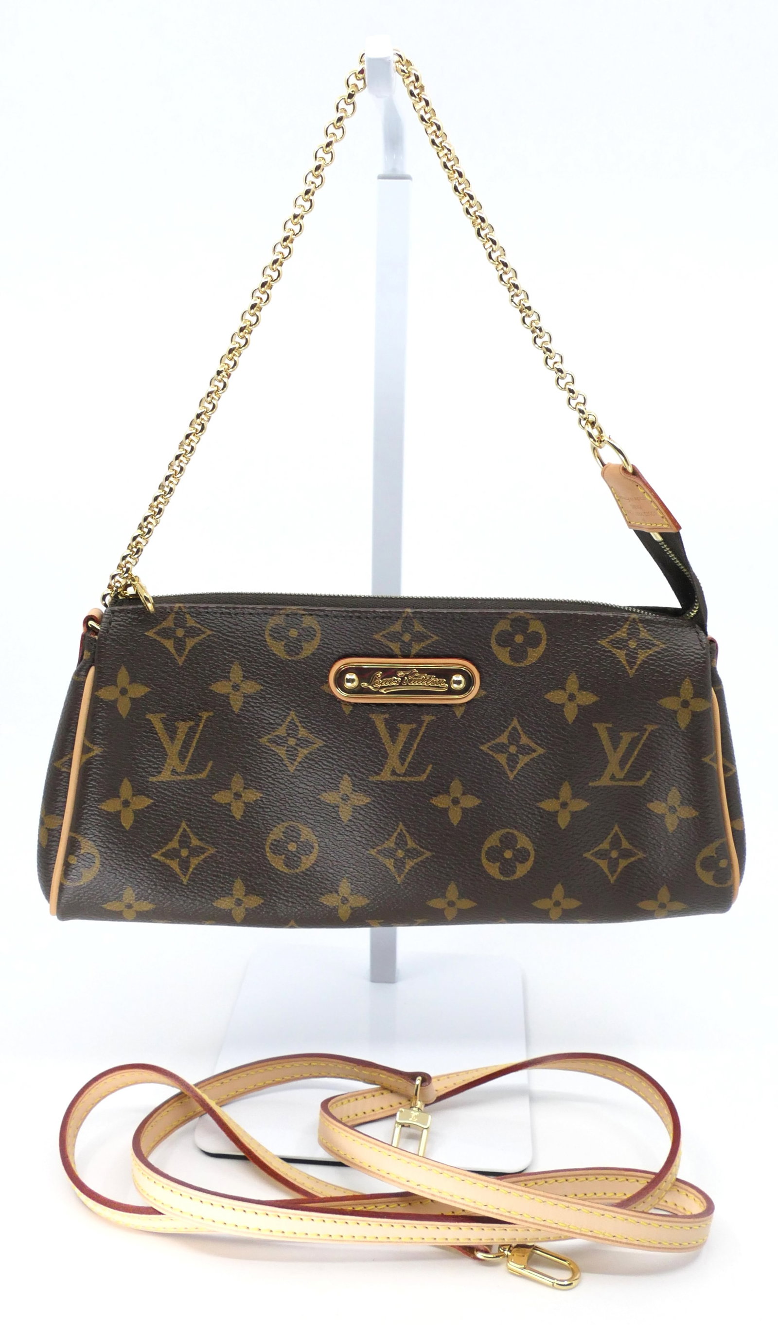 Louis Vuitton Eva Pochette Monogram Canvas Bag: Louis Vuitton Eva Pochette in classic monogram canvas with two straps, vachetta leather trim, gold tone hardware and fabric interior, 2009. Serial # AA0078. Excellent condition. Size: 10"w x 1.5"d x 5