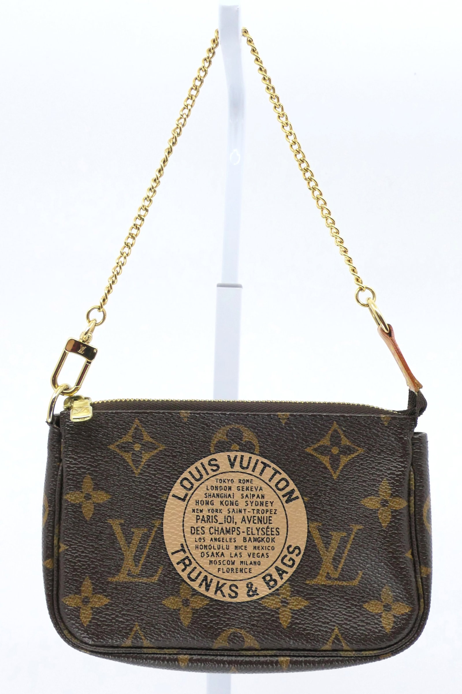 Louis Vuitton Trunks and Bags Mini Pochette Monogram Canvas Bag: Louis Vuitton Trunks and Bags mini Pochette Limited Edition in classic monogram canvas with vachetta leather trim, gold tone hardware and striped interior, 2007. Serial # FL1017. Excellent condition w