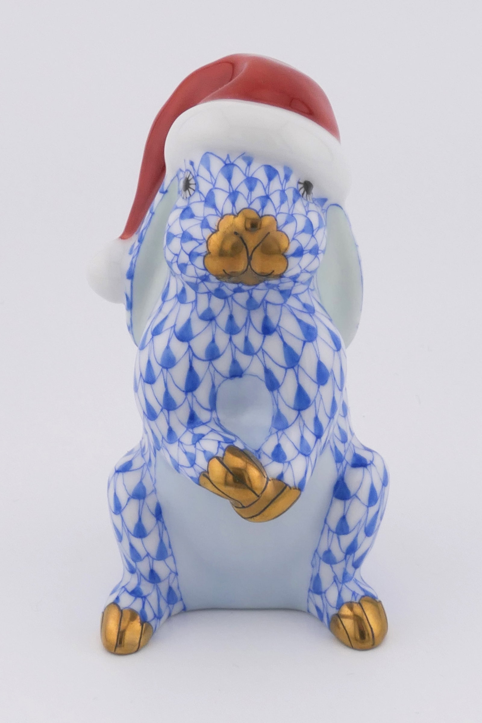 Herend Santa Rabbit Figurine: Marked Herend porcelain figurine featuring a rabbit design wearing a Santa hat in blue fishnet patterning. Marked on the bottom with the Herend insignia. Excellent condition. Size: 1.25"w x 2"d x