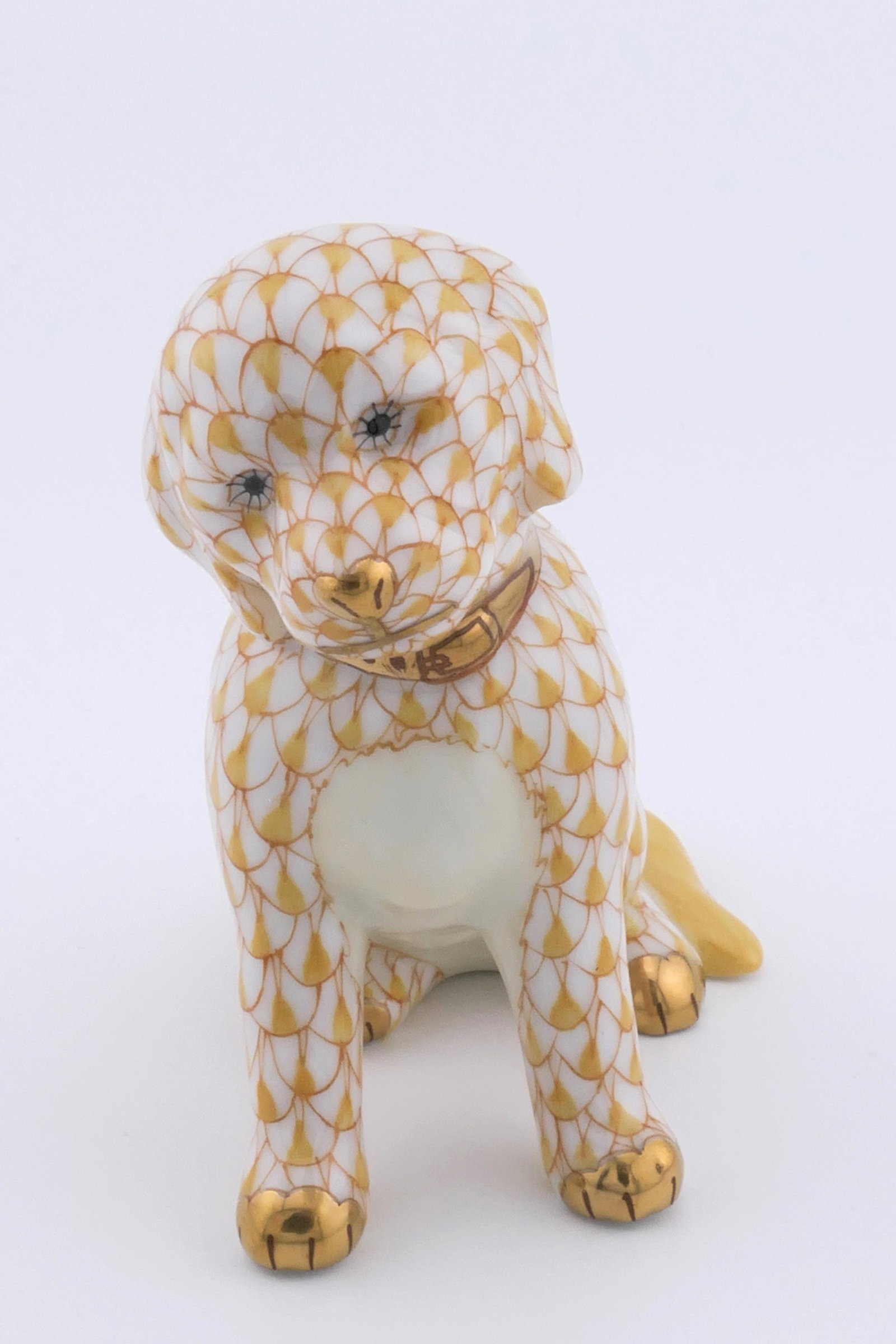 Herend Labrador Figurine: Marked Herend porcelain figurine featuring a Labrador Retriever design in butterscotch fishnet patterning. Marked on the bottom with the Herend insignia. Excellent condition. Size: 2.75"w x 1.5"d x