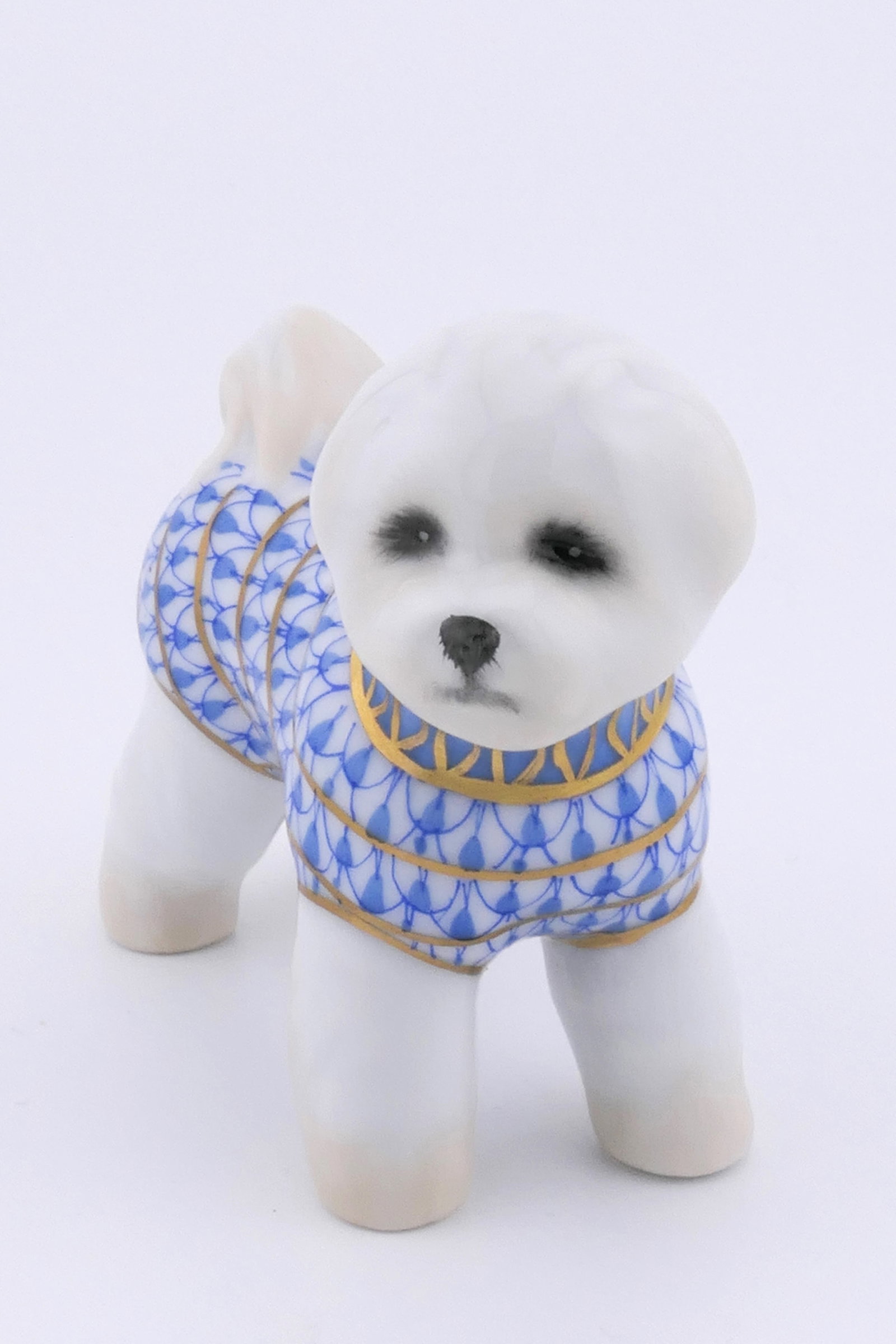 Herend Bishon Figurine: Marked Herend porcelain figurine featuring a Bishon Frise design in blue fishnet patterning. Marked on the bottom with the Herend insignia. Excellent condition. Size: 1.25"w x 3"d x 2.5"h Location: