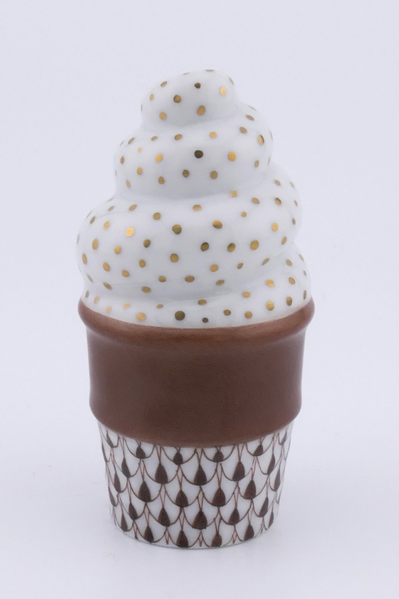 Herend Ice Cream Cone Figurine: Marked Herend porcelain figurine featuring an ice cream cone design in chocolate fishnet patterning. Marked on the bottom with the Herend insignia. Excellent condition. Size: 1"dia x 3"h Location: