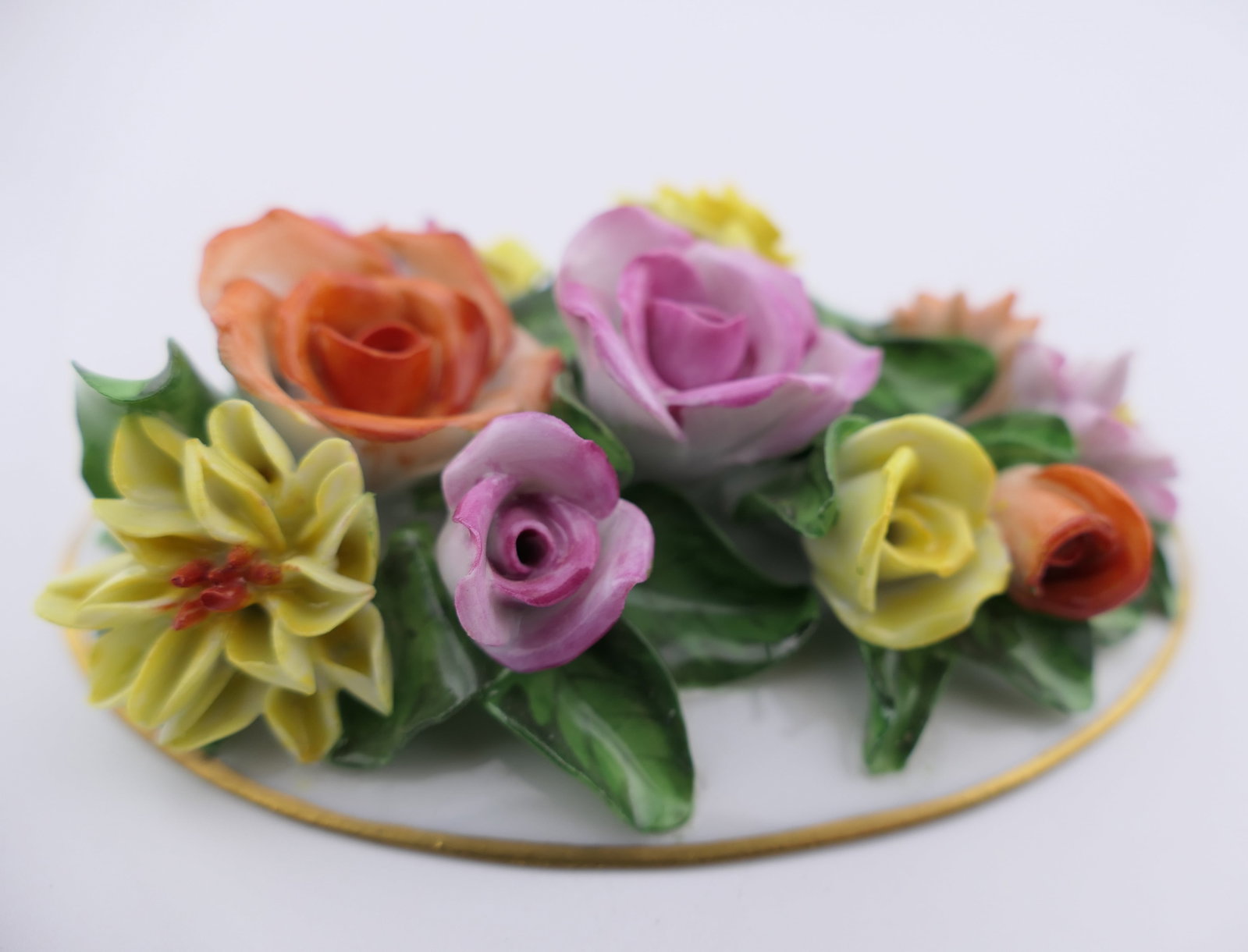 Herend Floral Accent Figurine: Marked Herend porcelain figurine featuring a colorful molded floral design on an oval plaque. Marked on the bottom Herend, Hungary. Excellent condition. Location: