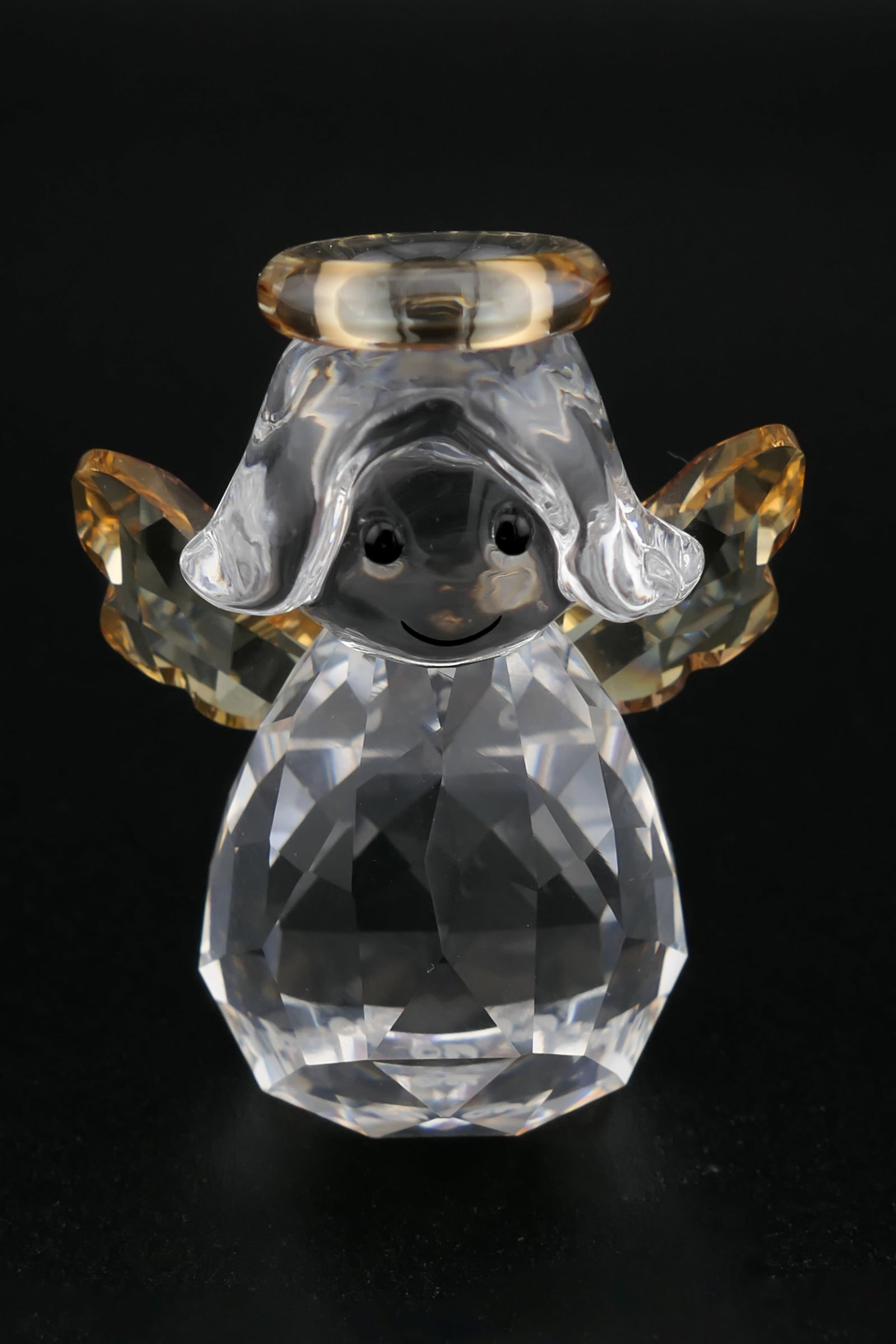 Swarovski Crystal Rocking Angel Figurine: Swarovski crystal figurine featuring an angel with gold tone wings and halo, on a bulbous base intended to rock back and forth. Etched on the bottom with the Swarovski insignia. Excellent condition. S