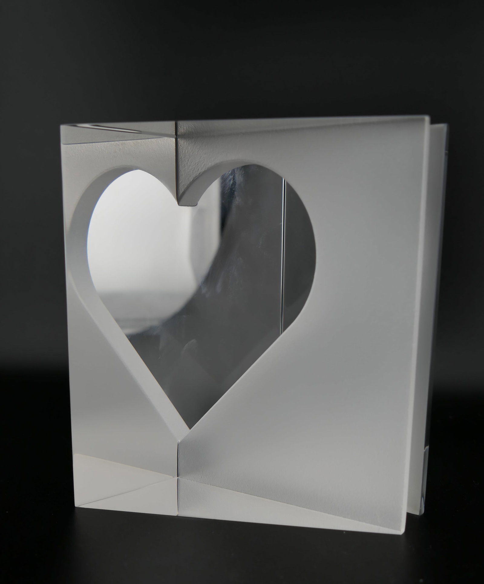 Steuben Crystal Love at First Sight Paperweight: Marked Steuben crystal paperweight featuring a triangular prism design by Paul Schulze intended to create the illusion of a complete heart through the prism. Etched on the bottom Steuben. Excellent co