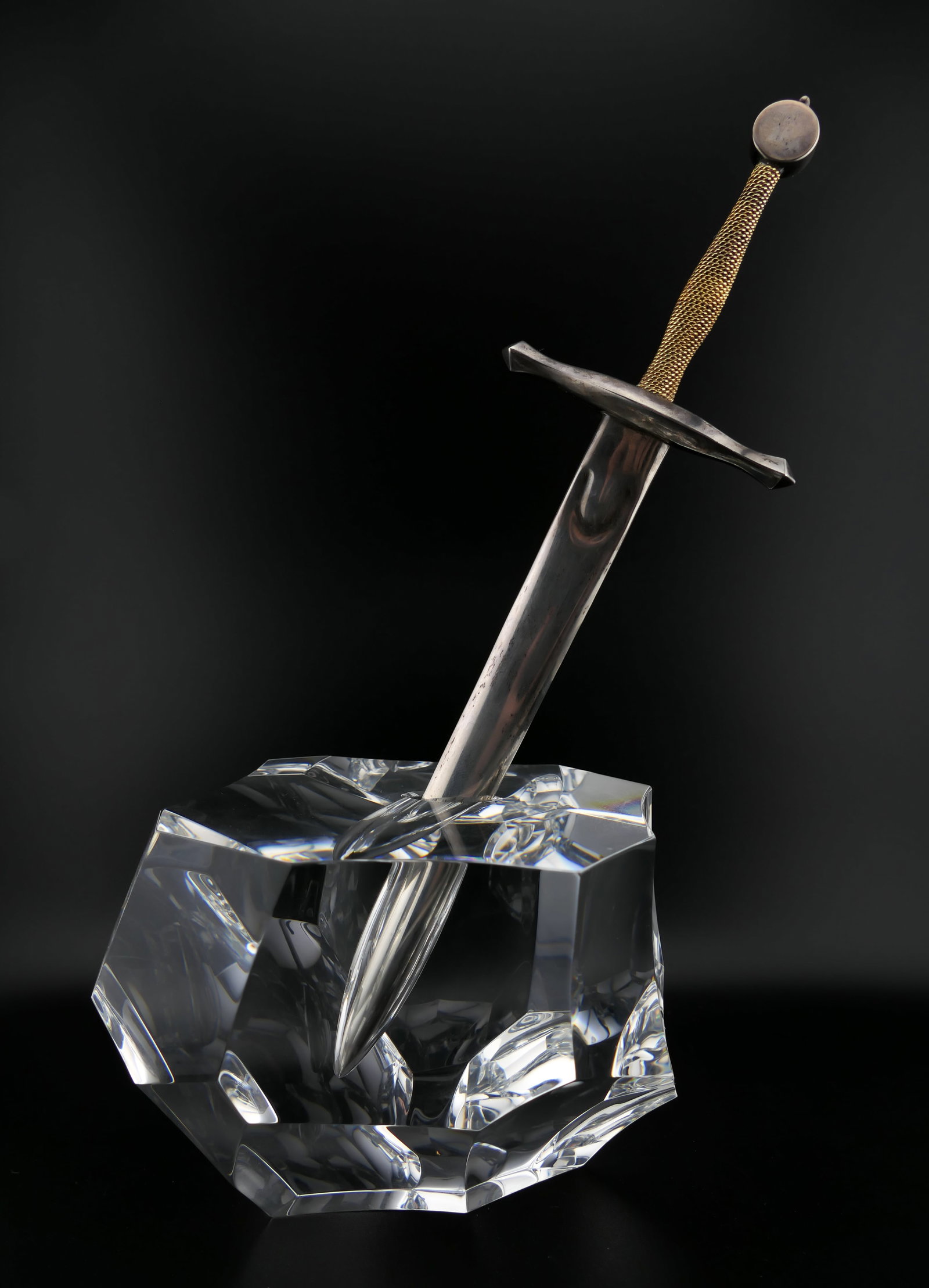 Steuben Crystal Sword in the Stone Paperweight: Marked Steuben crystal paperweight featuring a Sword in the Stone design, set with a sterling silver letter opener with 18k yellow gold accents. Marked on the edge of the hilt sterling and 18k. Also e