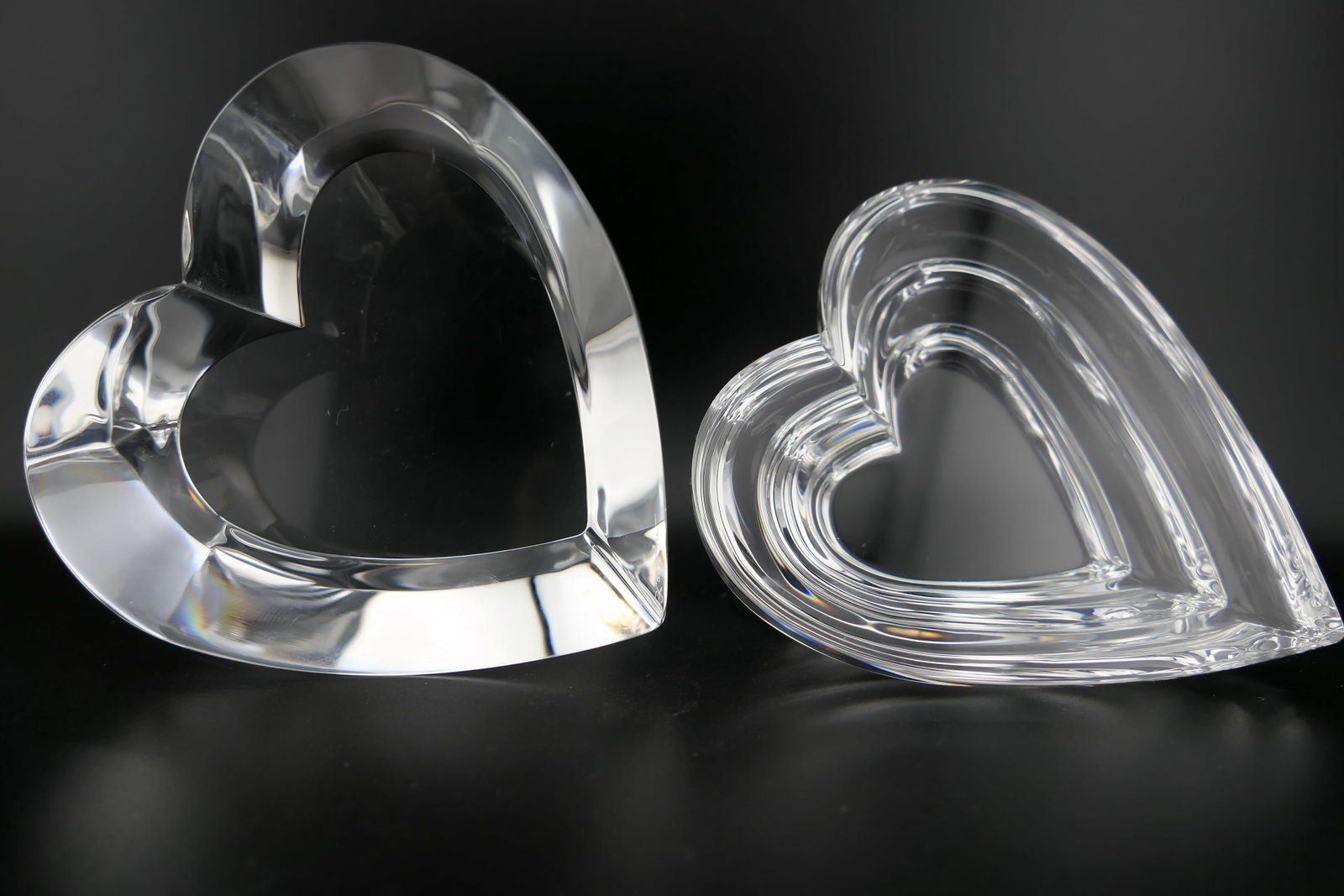 Steuben Crystal Heart Paperweights: Two marked Steuben crystal paperweights featuring heart designs titled Two Hearts, and Forever More, both designed by Eric Hilton, and etched along the edge Steuben. Excellent condition. Size: Two Hea