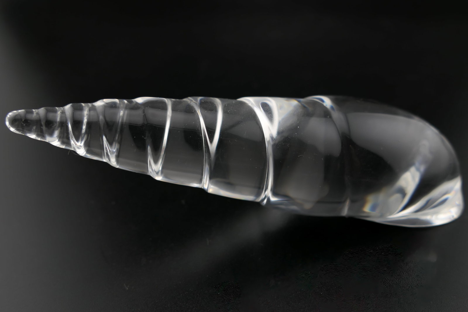 Steuben Crystal Terebra Seashell Paperweight: Marked Steuben crystal paperweight featuring a twisted shell design titled Terebra, designed by Paul Schulze. Etched along the bottom Steuben. Excellent condition. Size: 4"w x 1"d x 1.5"h Location: Li