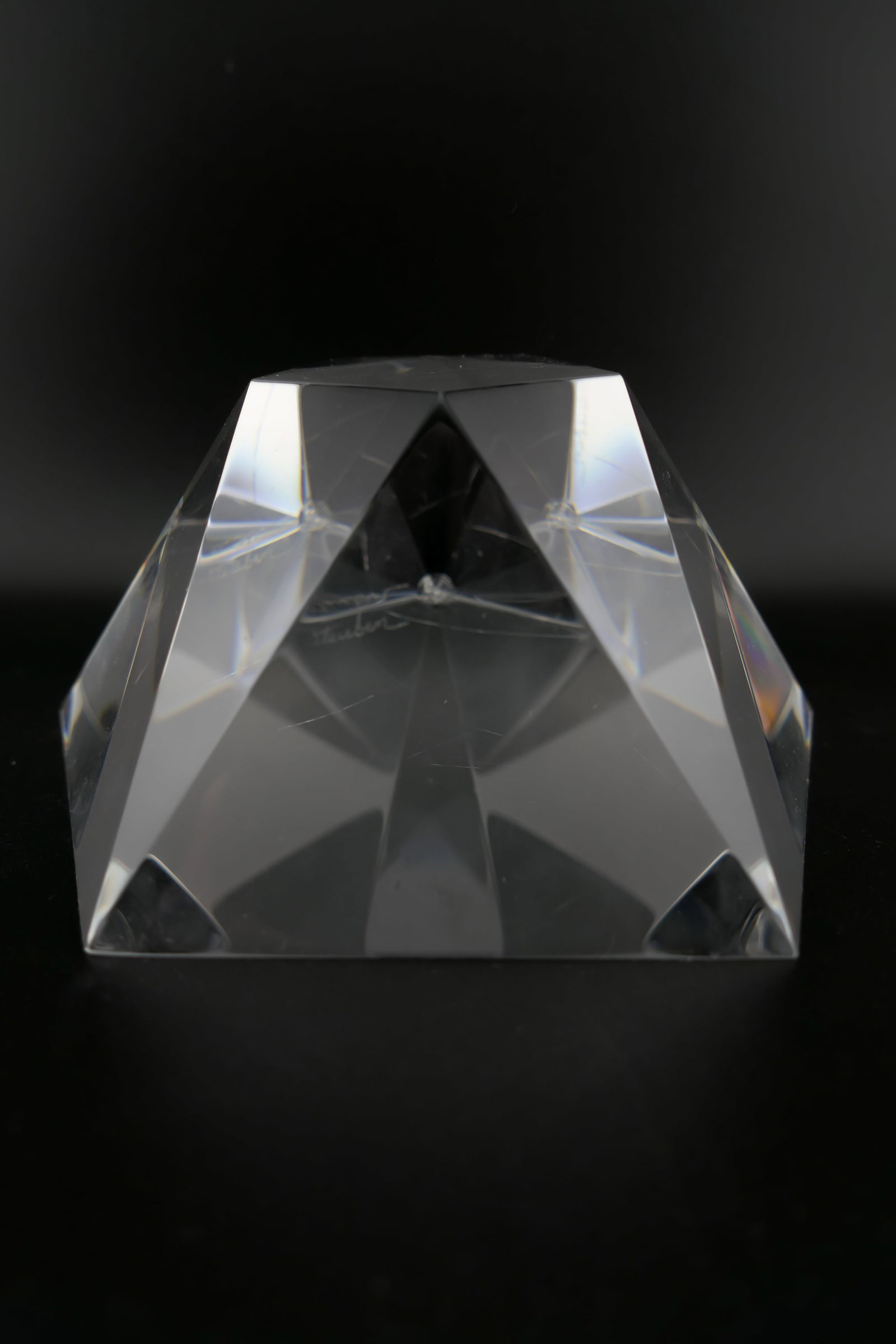 Steuben Crystal Rising Star Paperweight: Marked Steuben crystal paperweight in the Rising Star prism motif designed by Robert Cassetti. Etched Steuben along one edge. Very good condition with a small chip at one corner. Size: 4.25"sq x 2"h L