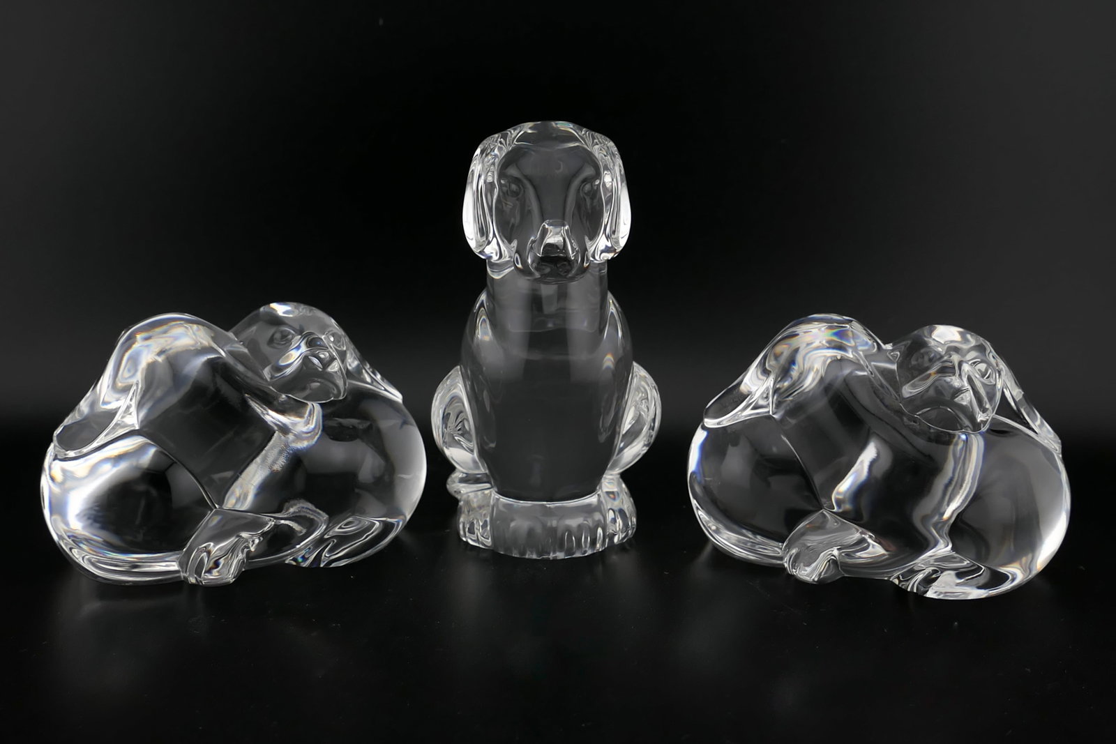 Steuben Crystal Dog Hand Coolers: Three marked Steuben crystal hand coolers featuring dogs including two titled Puppy Love. Both are etched along the bottom Steuben. Excellent condition. Size: Larger 2"w x 1.5"d x 3.25"h Location: