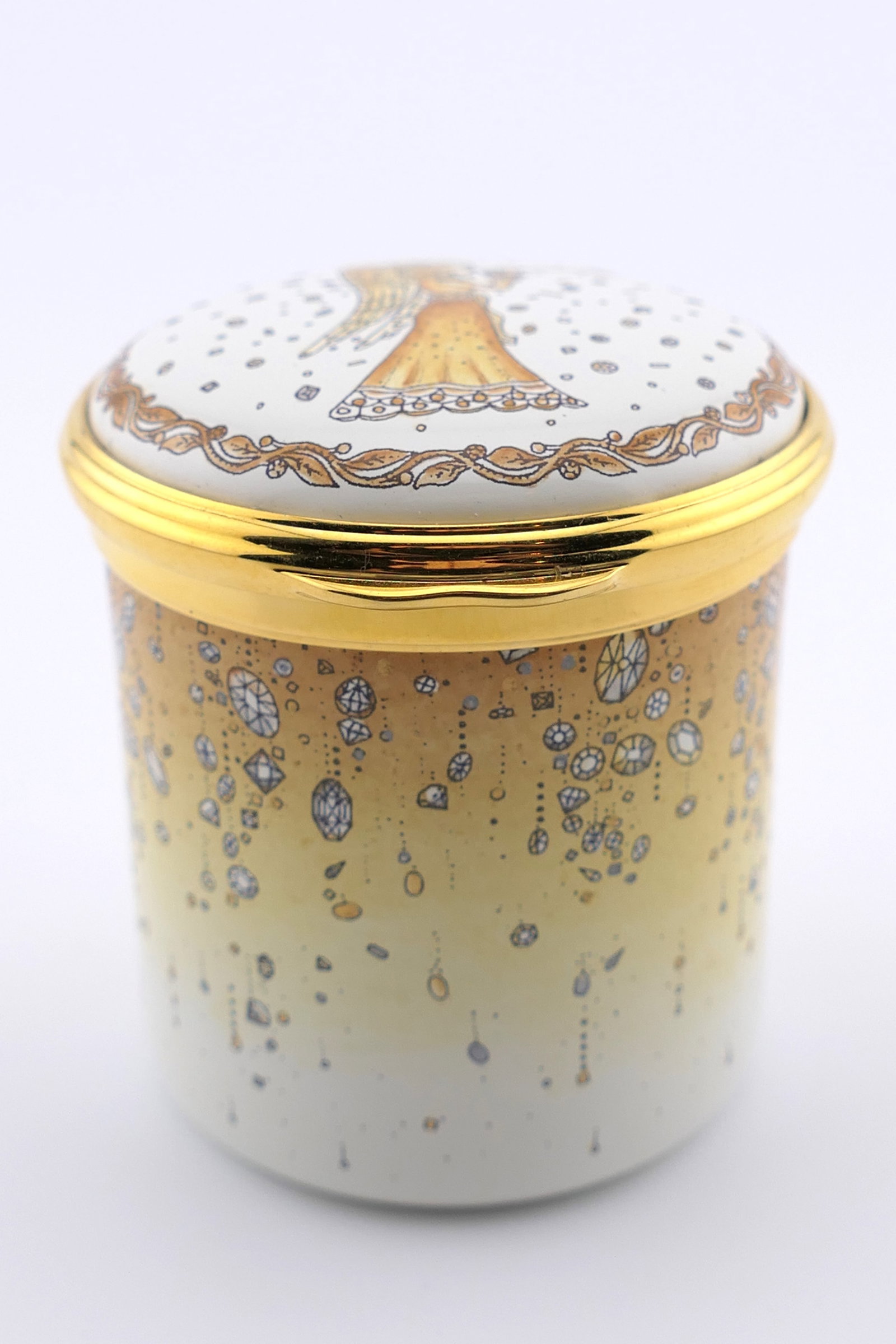 Halcyon Days Neiman Marcus Trinket Box: Marked Halcyon Days hinged trinket box featuring an ombre yellow to cream motif on the cylindrical circa 2016. Marked on the bottom Halcyon Days Made Exclusively for Neiman Marcus. Excellent