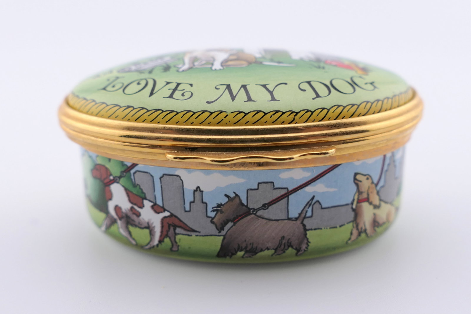 Halcyon Days Tiffany and Co Trinket Box: Marked Halcyon Days hinged trinket box featuring a colorful dog motif, and made exclusively for Tiffany & Co. Also features a fire hydrant design inside. Marked on the bottom Halcyon Days Enamels Desi