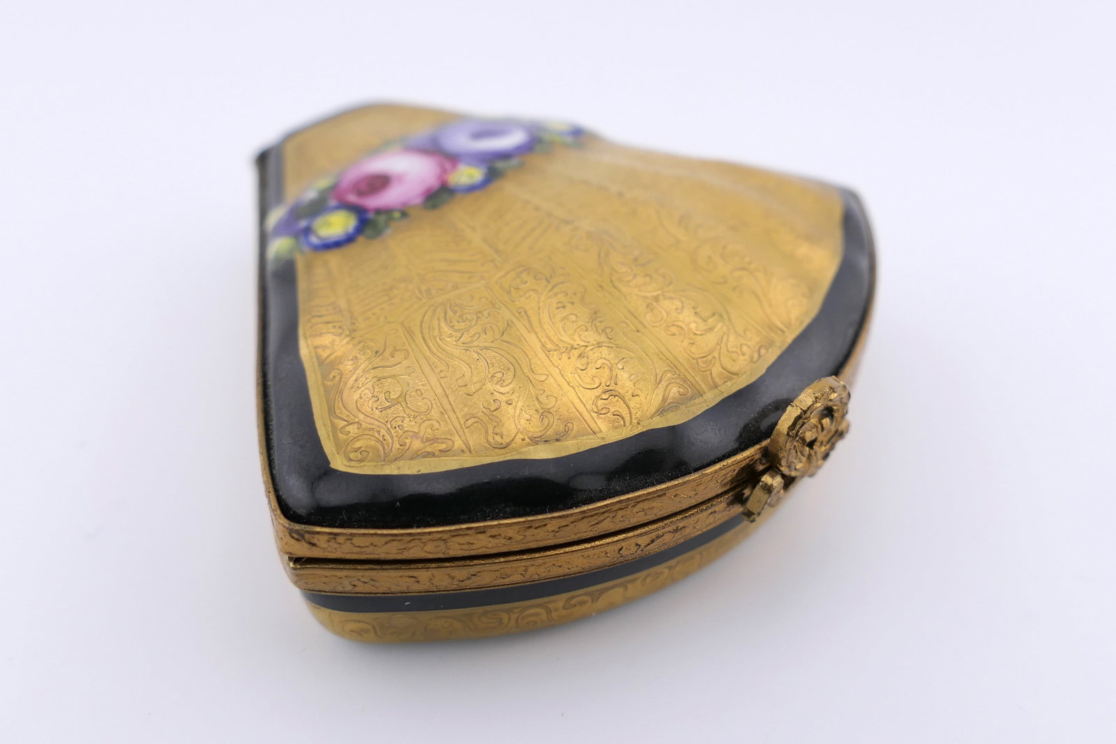 Limoges Porcelain Gilt Fan Trinket Box: Limoges hand painted porcelain hinged trinket box featuring a gilt and floral design in a fan shape. Marked on the bottom Limoges France. Excellent condition. Size: 2.5"sq x 0.5"h Location: Living Roo