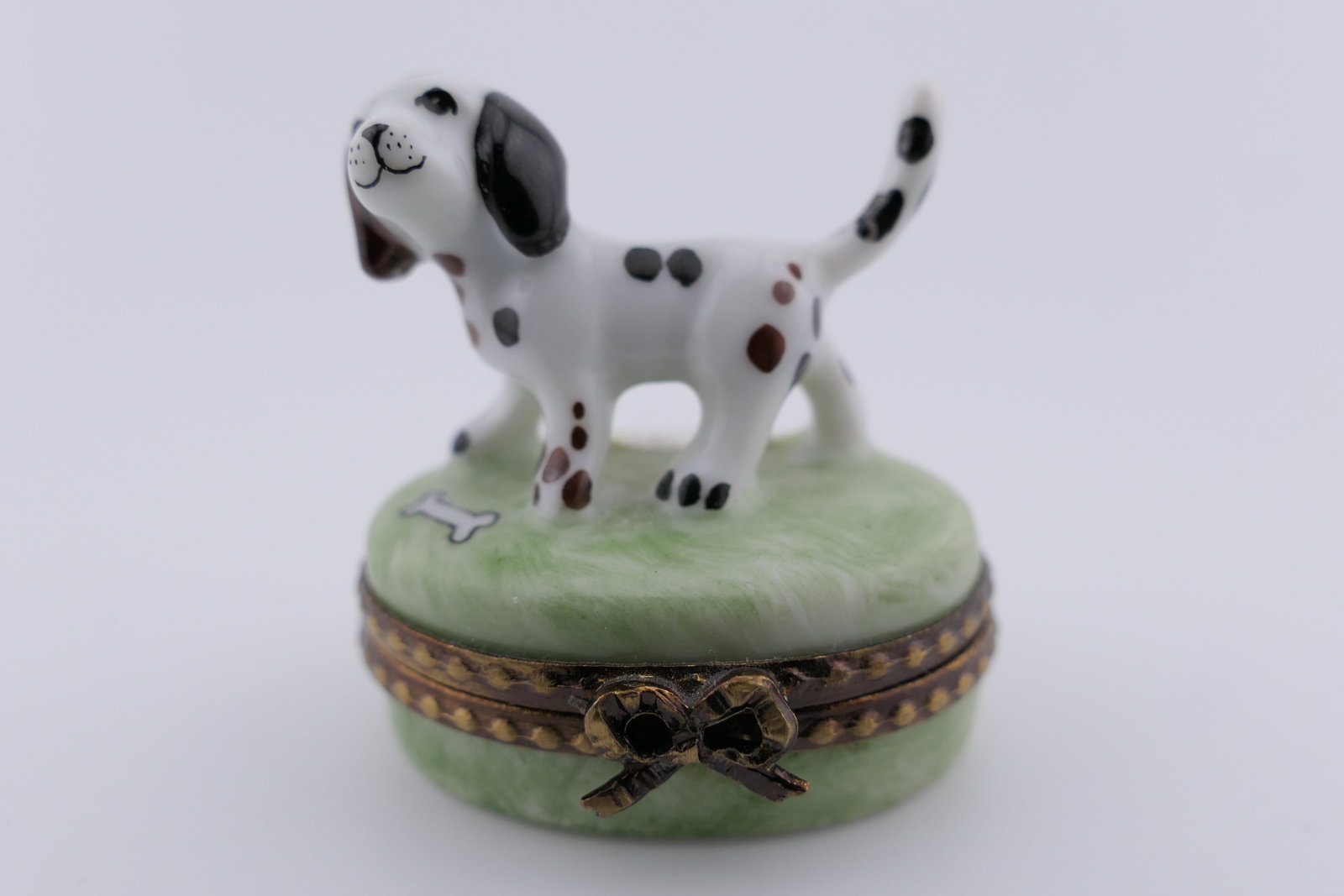 Limoges Porcelain Dog Trinket Box: Limoges hand painted porcelain hinged trinket box featuring a design of a dog with a spotted coat. Marked on the bottom Limoges France. Excellent condition. Size: 1.5"w x 1.25"d x 1.5"h Location: Livi