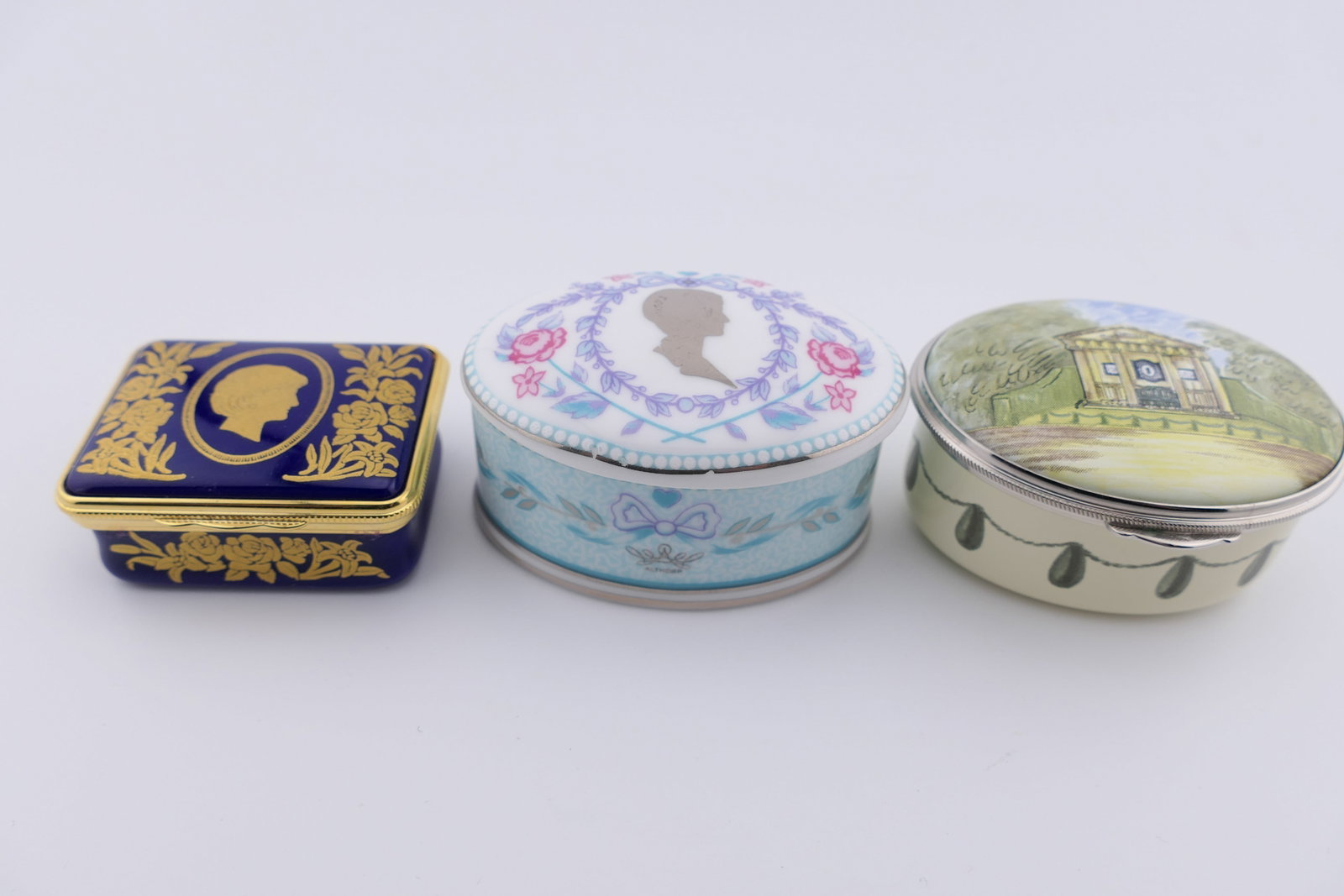 Three Princess Diana Commemorative Trinket Boxes: Three trinket boxes commemorating Princess Diana, one marked for Halcyon Days in a limited edition titled "The Work Continues", and numbered 86/500. Very good condition with minor color loss. Size: La